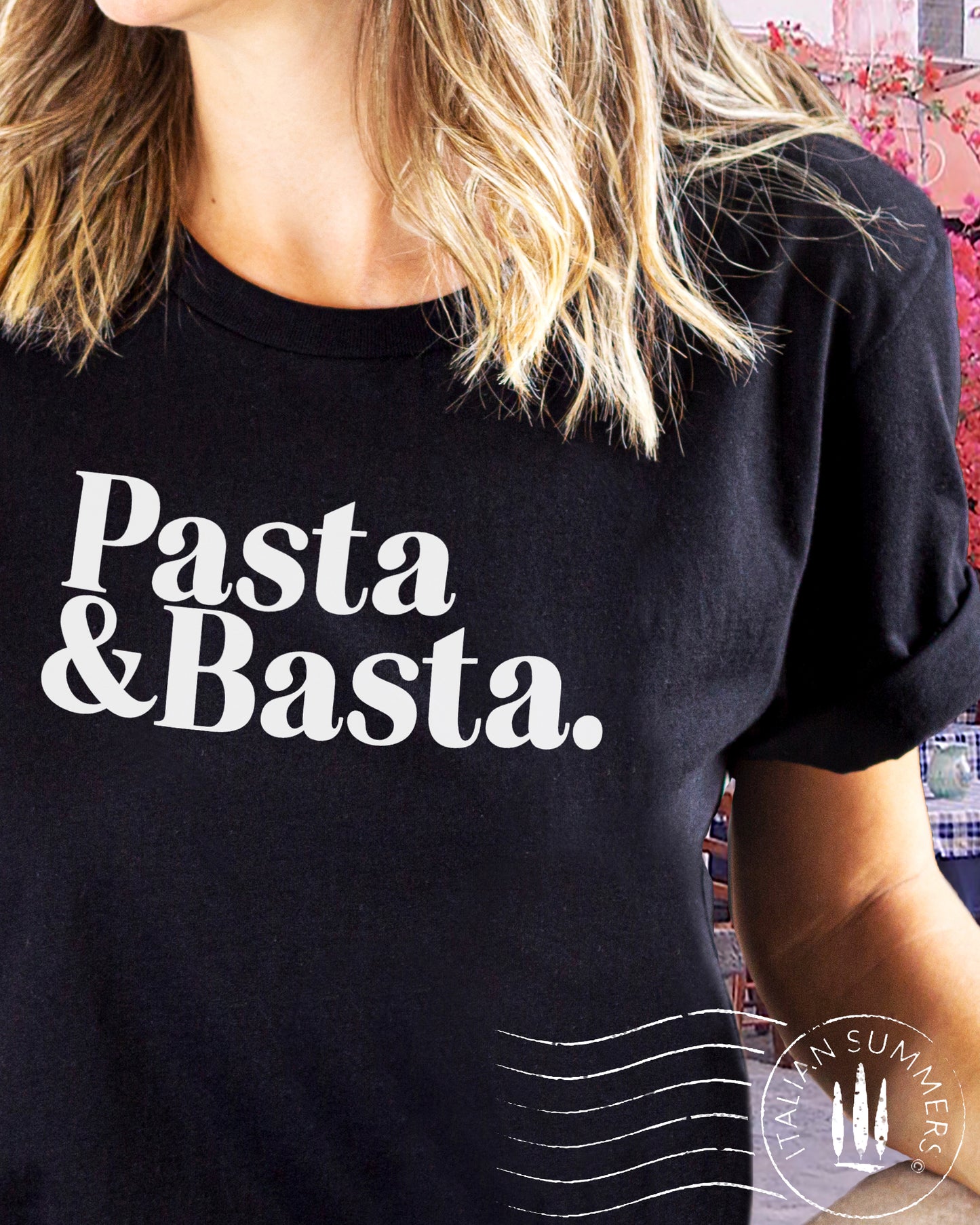 A girl is wearing an Italy-inspired black Unisex crew neck T shirt with a large retro text: Pasta & Basta.