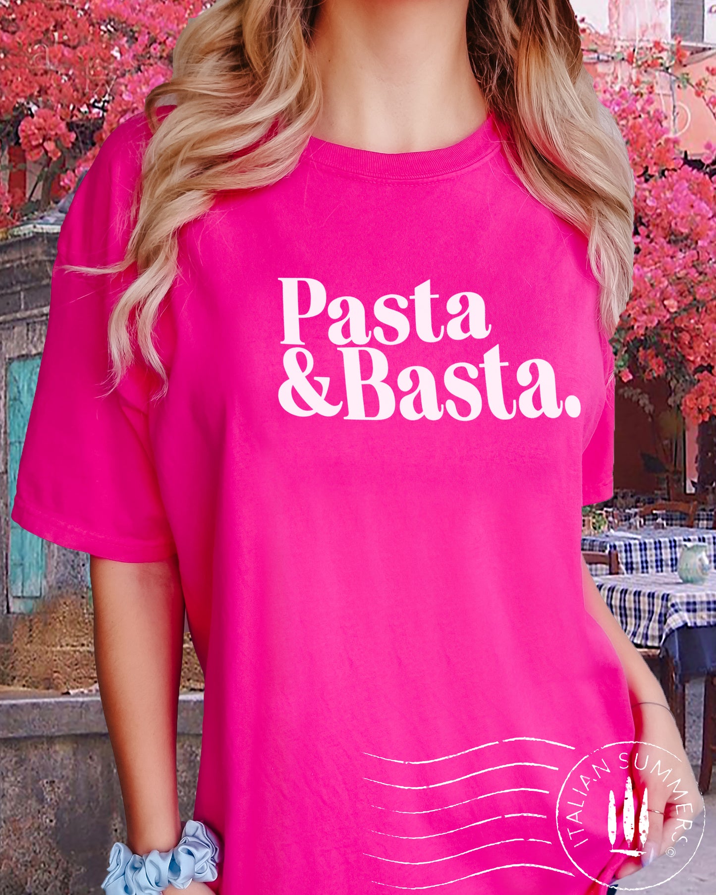 A girl is wearing an Italy-inspired fuchsia Unisex crew neck T shirt with a large retro text: Pasta & Basta.