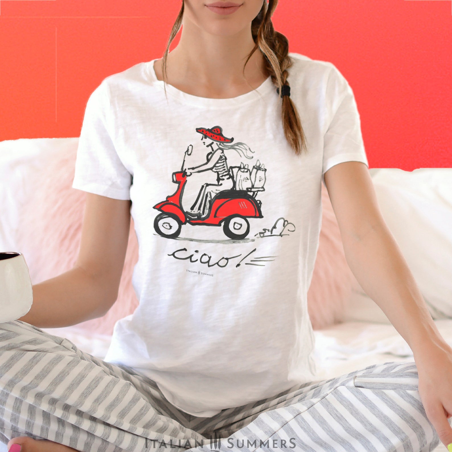 Italy-Inspired white T shirt VESPA CIAO, features a print of our original handpainted design of a fashionable girl with a big summer straw hat speeding through an Italian town with shopping bags on a vintage red Vespa.
