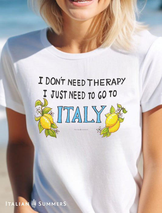 A happy cotton T shirt featuring the text: I dont need Therapy, I just need to go to Italy. The phrase is flanked by two bunches of leafy Sorrento Lemons from the Amalfi Coast, and the word ITALY is in a light marine blue. By Italian Summers