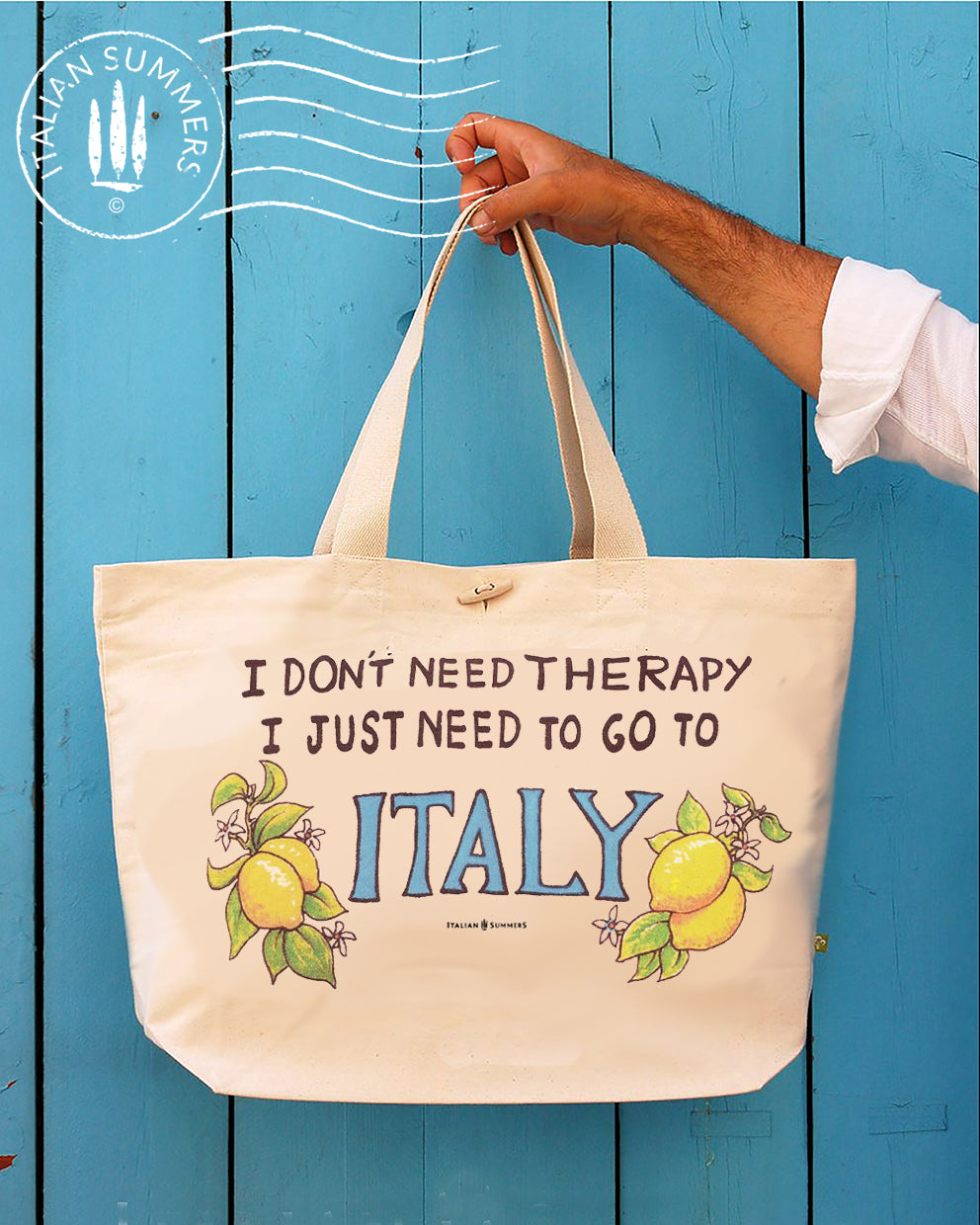 Tote bag with the quote " I don't need therapy, I just need to go to Italy " .The quote is flanked by Amalfi lemons with flowers. Designed and sold by Italian Summers