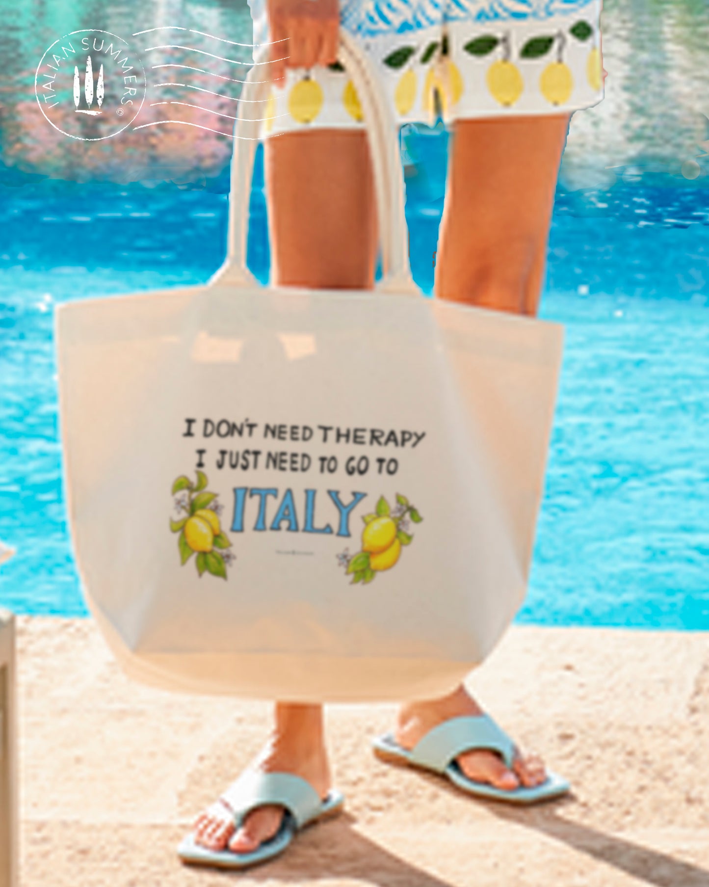 Tote bag with the quote " I don't need therapy, I just need to go to Italy " .The quote is flanked by Amalfi lemons with flowers. Designed and sold by Italian Summers