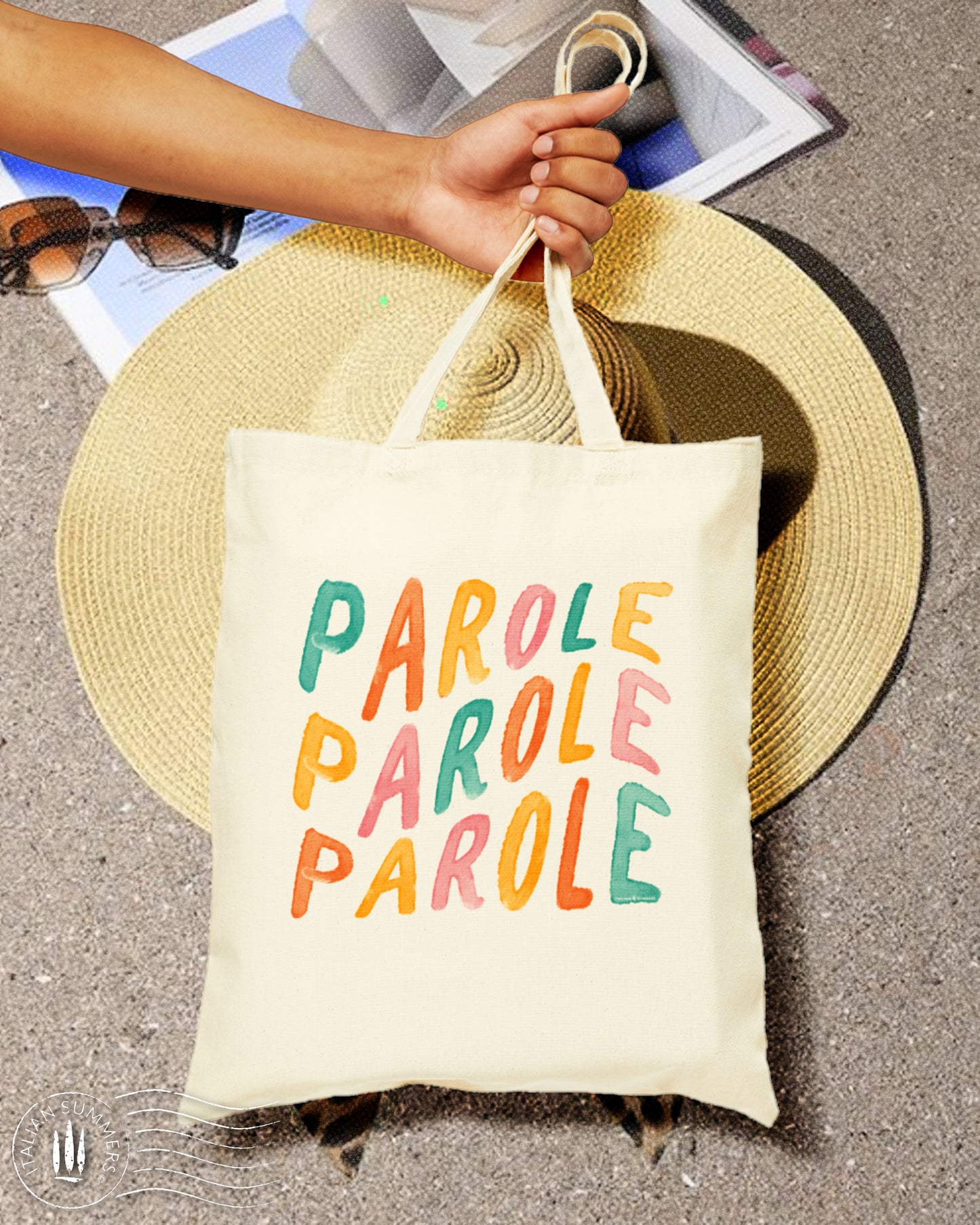 A happy-looking Natural Cotton Tote bag with the Italian quote 'Parole Parole Parole, printed with hand-brushed multi-colored letters. Perfect for the beach, shopping or just a stroll in the Piazza.