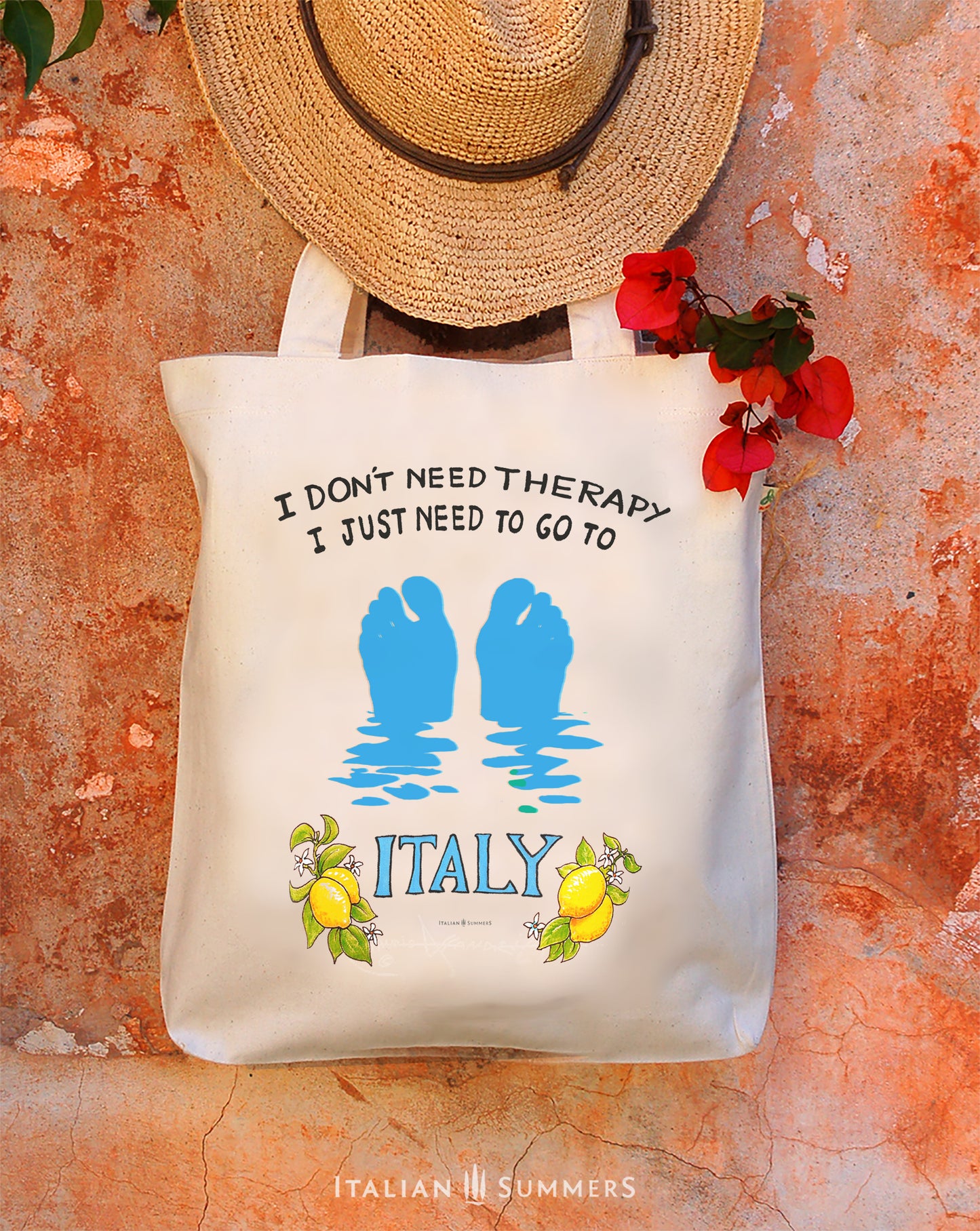 An Italy inspired cotton tote bag. It features our favorite illustrated Italy quote I don't need therapy, I just need to go to Italy with lemons and a blue 'ITALY'. We added the azure silhouette of two floating footsies just sticking out of the waters of the Mediterranean Sea! Designed by Italian Summers