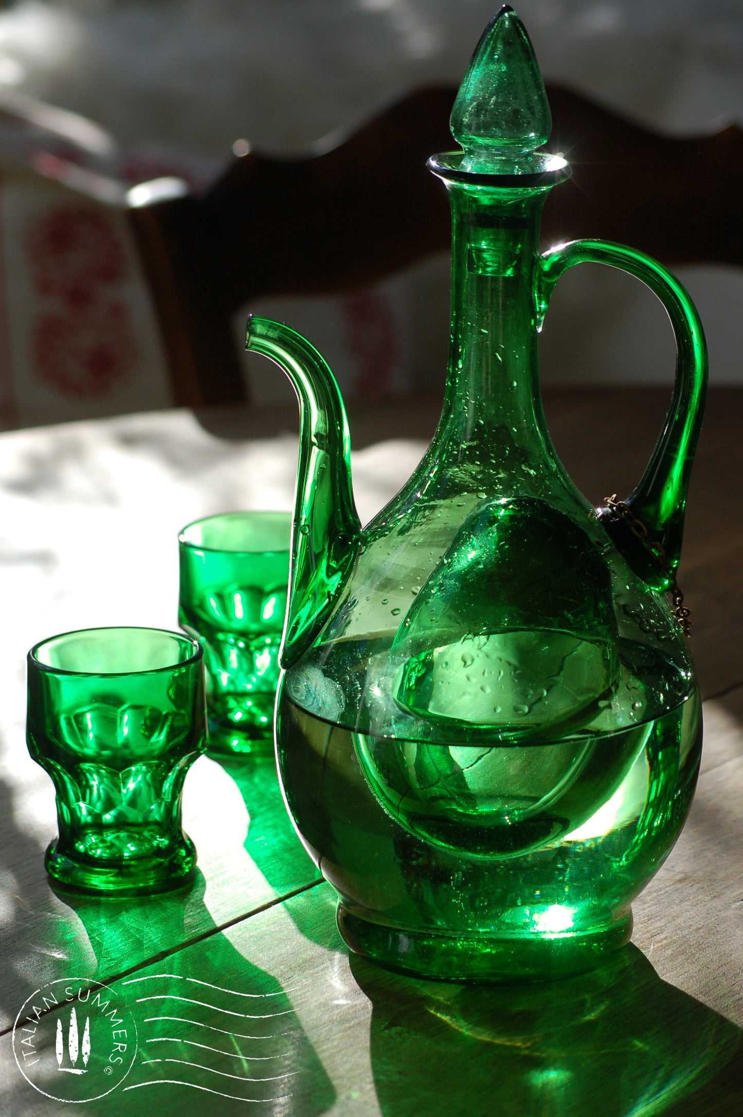 A beautiful emerald green Empoli glass decanter from the 1960s Italy. It resembles a large teardrop with a spout  and a handle, made of hand-blown green glass. It has an inner chamber built-in  for ice cubes that will chill the wine without diluting it.  A small work of Art, Italian Style