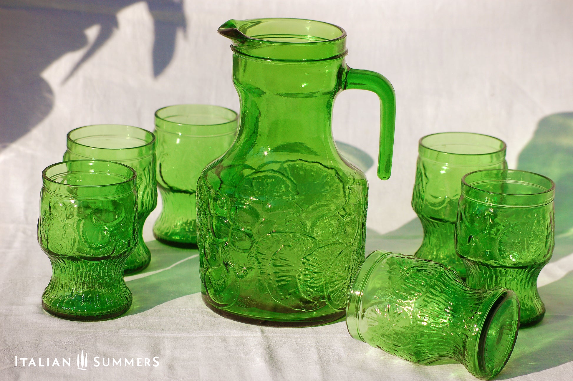 Italy vintage green glass set  by Bormioli with embossed Lemon slices, 6 tumblers and a carafe by Italian Summers
