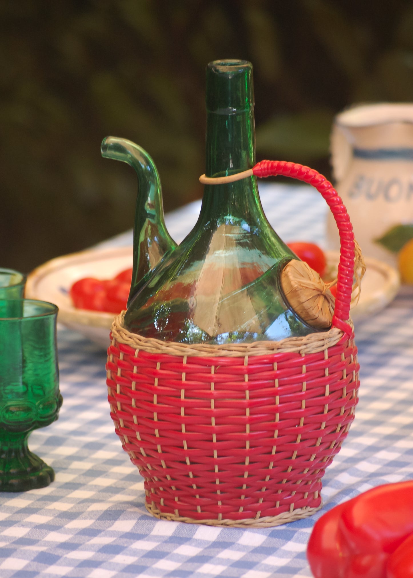 Vintage 1960s Italian emerald-green Empoli glass decanter with ice chamber. Red wicker decorated. Hand-blown in Tuscany.
