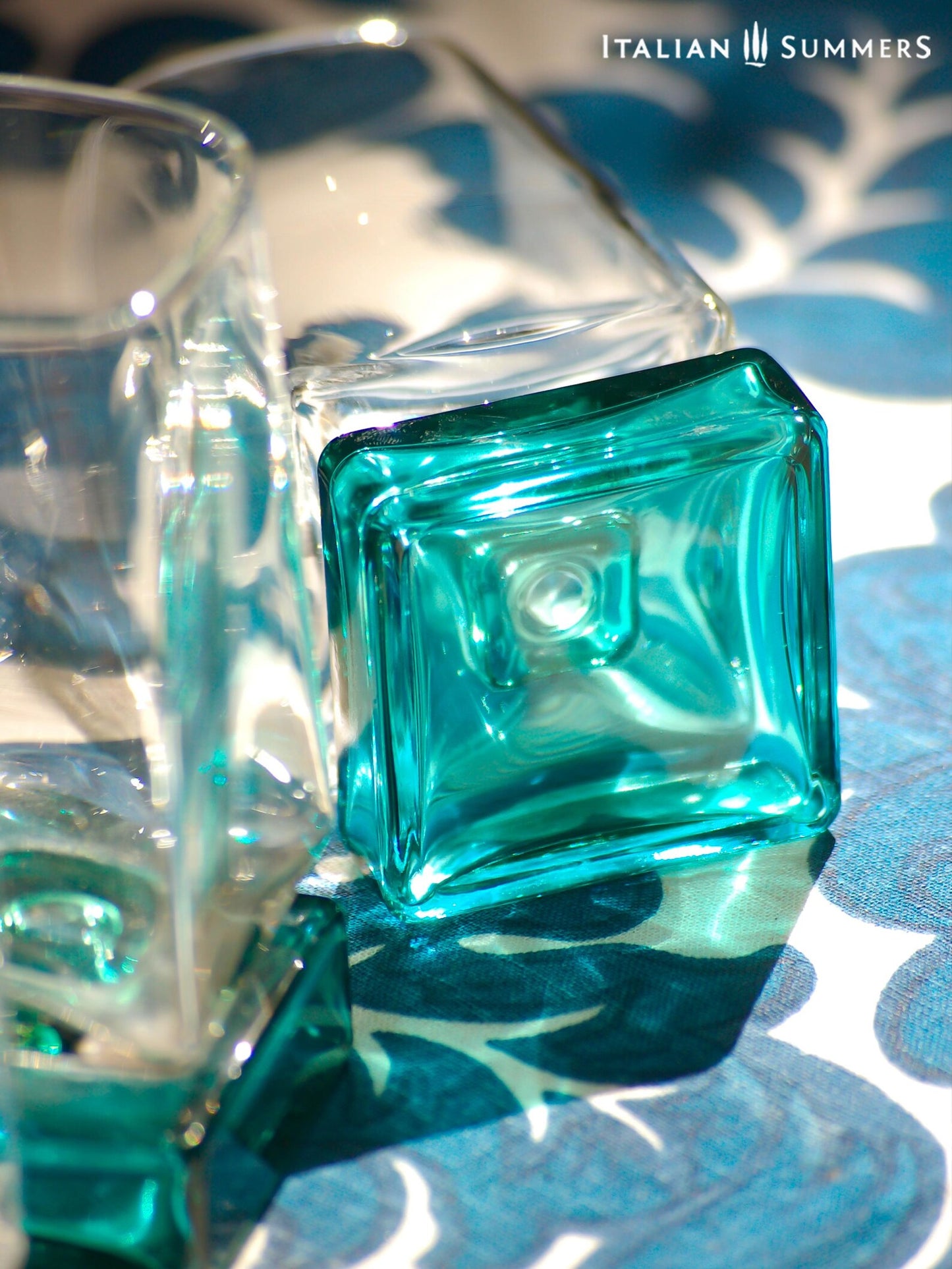 Vintage Bormioli Monet glass set from Italy, featuring square whiskey glasses with bold green foot and matching decanter, displayed on a table in retro style.