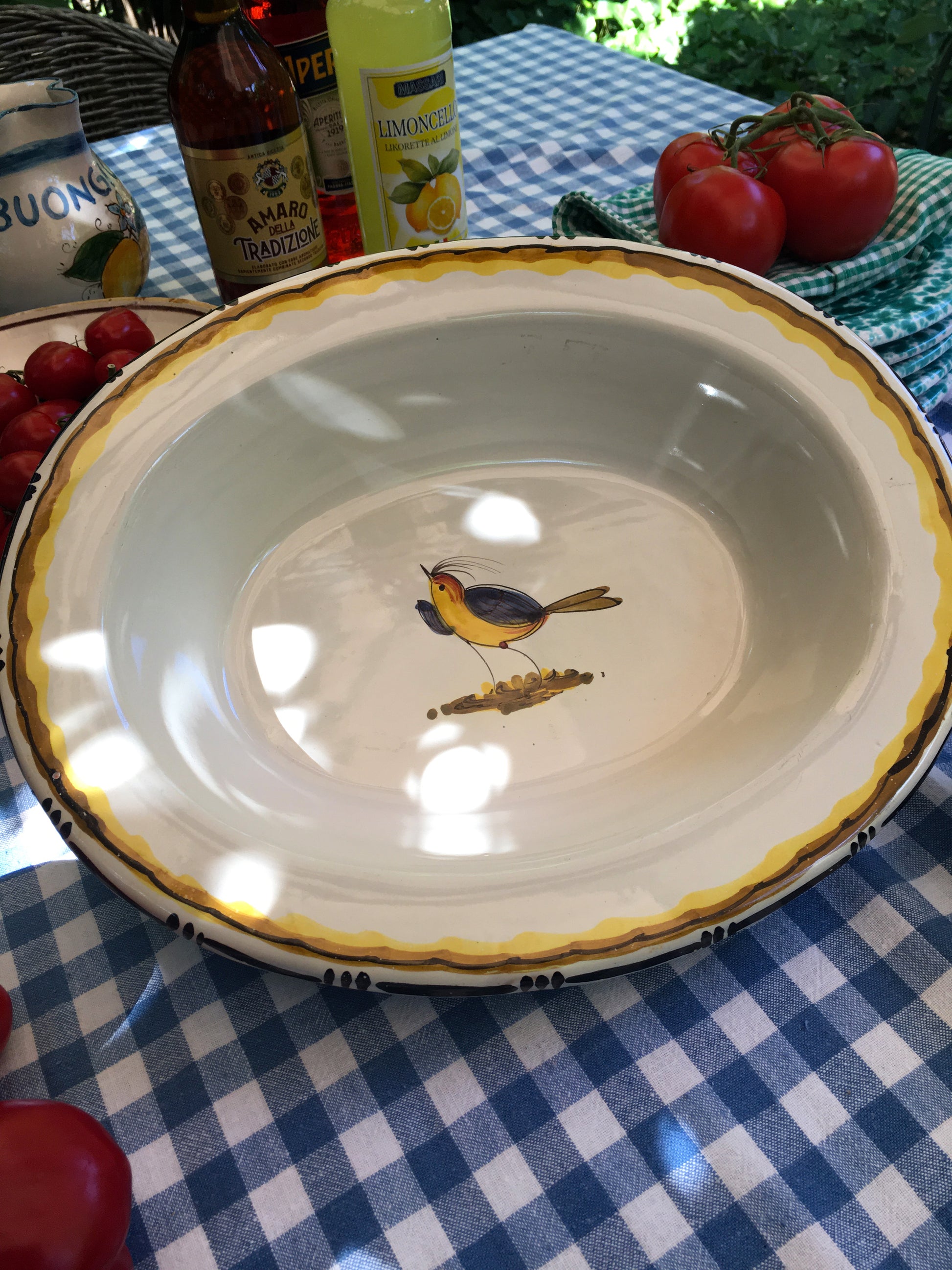 Vintage ceramic serving plate with hand-painted bird in the center from Tuscany