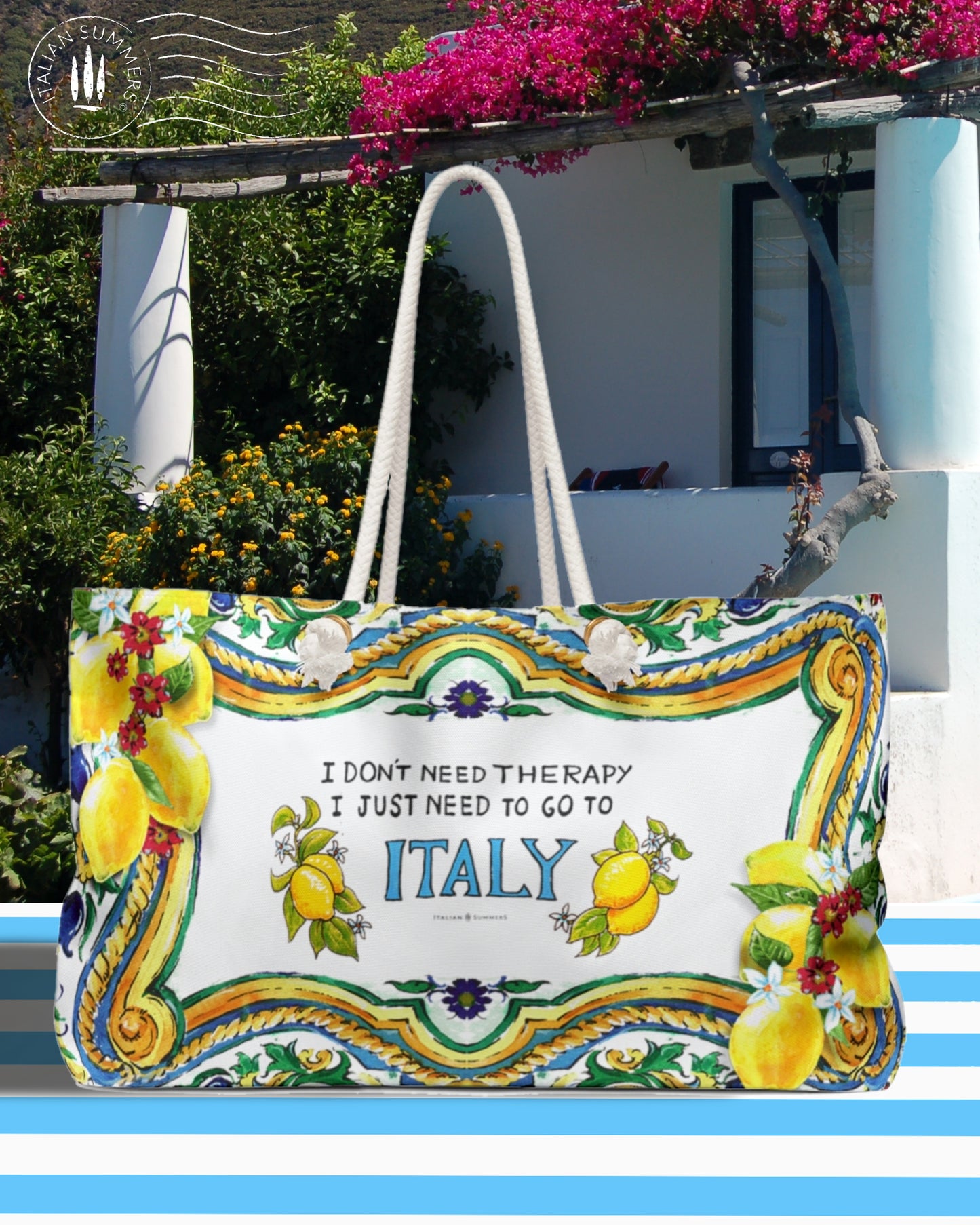 Large Italy inspired beach bag with the quote I don't need therapy, I just need to go to Italy. The Italy is in blue and on both sides of Italy are Sorrento lemons. The rims of the bag are decorated with Sicilian baroque convolutes, lemons and pieces of tiles. Printed on 2 sides. The bag has soft rope handles.