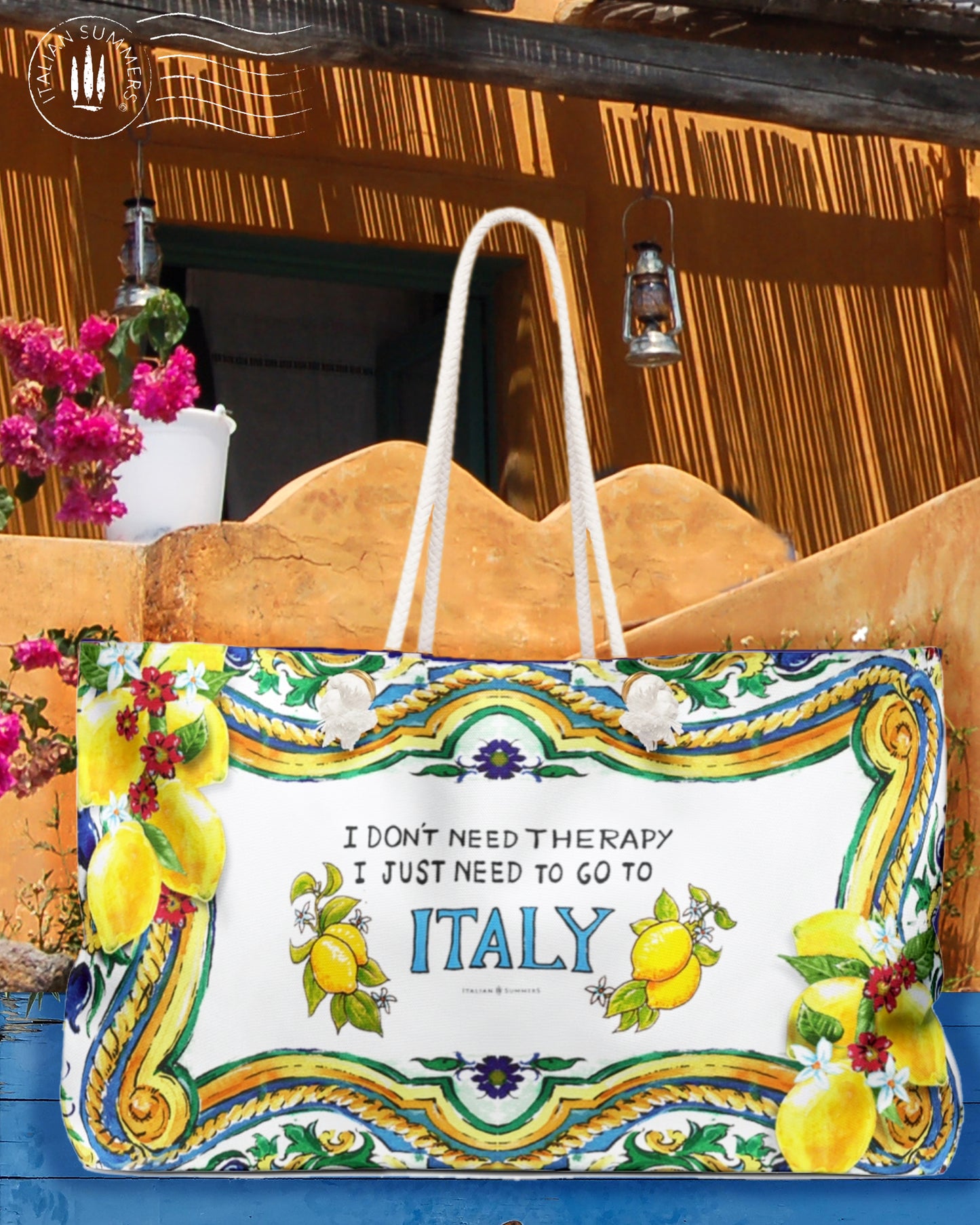 Large Italy inspired beach bag with the quote I don't need therapy, I just need to go to Italy. The Italy is in blue and on both sides of Italy are Sorrento lemons. The rims of the bag are decorated with Sicilian baroque convolutes, lemons and pieces of tiles. Printed on 2 sides. The bag has soft rope handles.