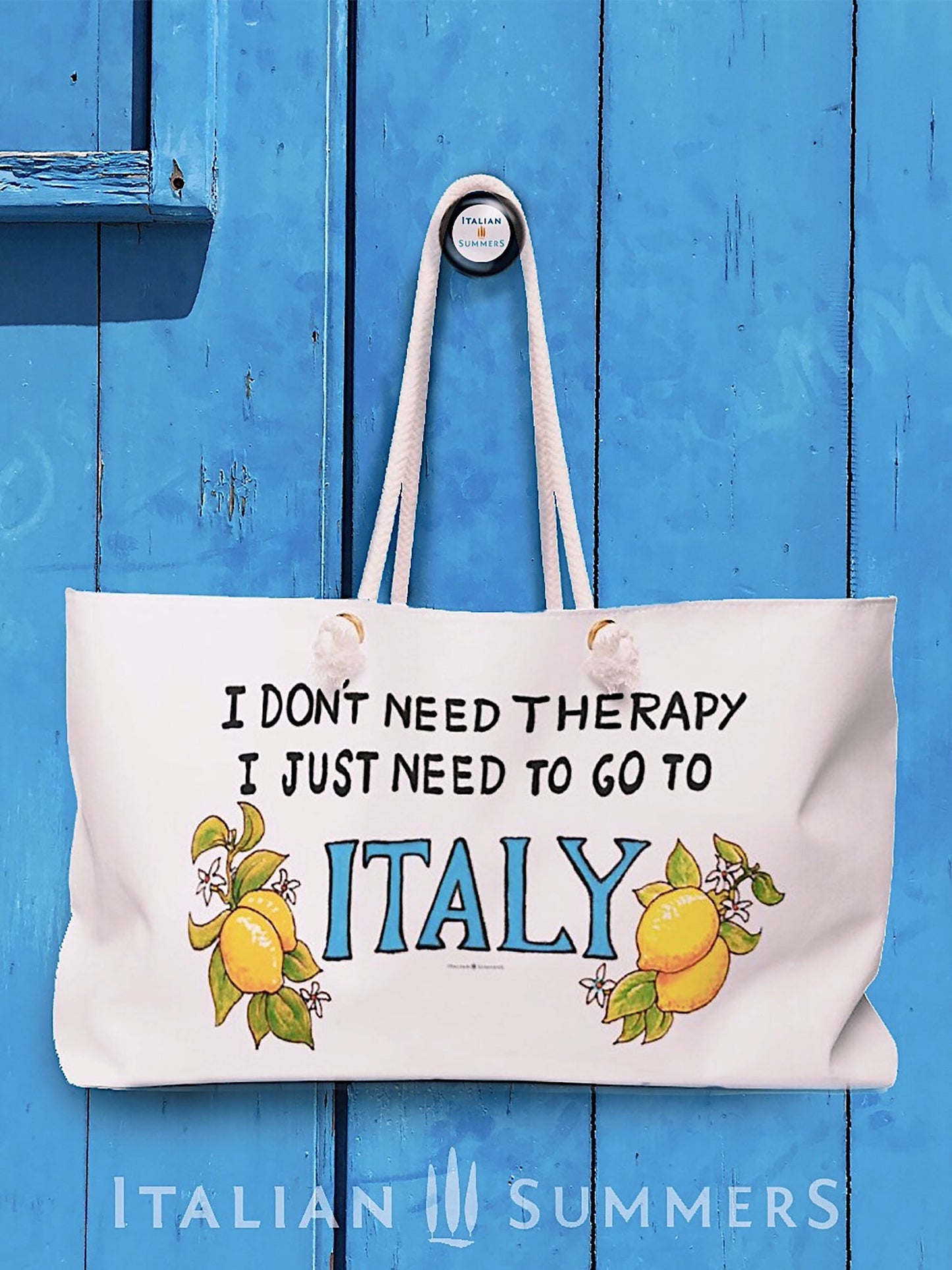 Italy inspired large beach bag with the quote I don't need therapy, I just need to go to Italy, with Italy in a blue hand writing. The Italy writing is decorated wirh amalfi Coast lemons on both sides. The beach bag has rope handles