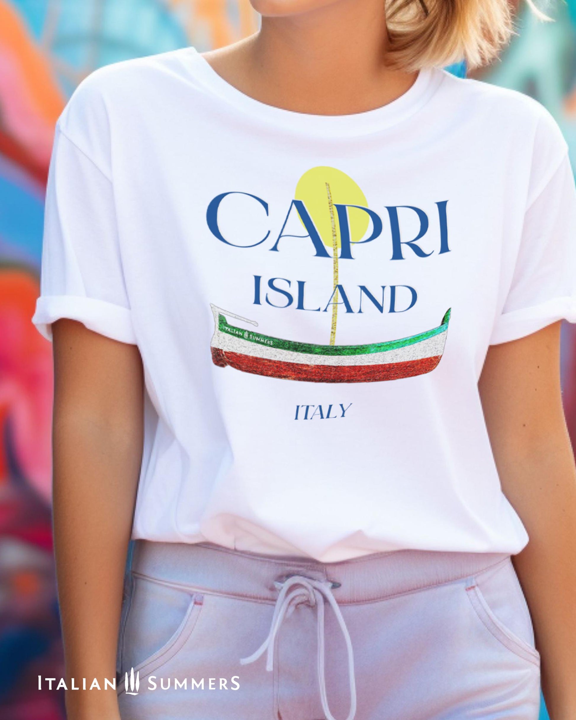 A Garment-dyed quality whiteT shirt with a print of a traditional Capri Island wooden boat in the color of the Italian flag, and the text CAPRI in capital letters above it, with a full-moon disk above.