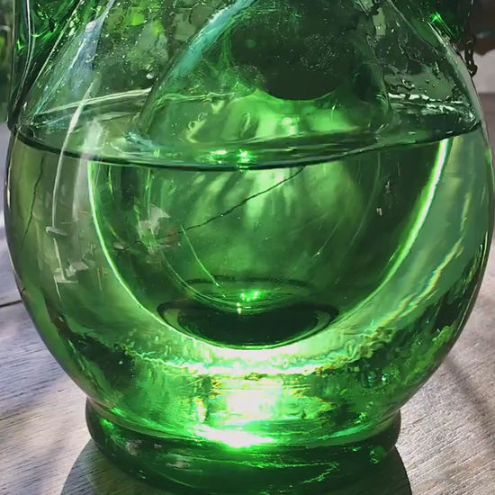 A beautiful emerald green Empoli glass decanter from the 1960s Italy. It resembles a large teardrop with a spout  and a handle, made of hand-blown green glass. It has an inner chamber built-in  for ice cubes that will chill the wine without diluting it.  A small work of Art, Italian Style