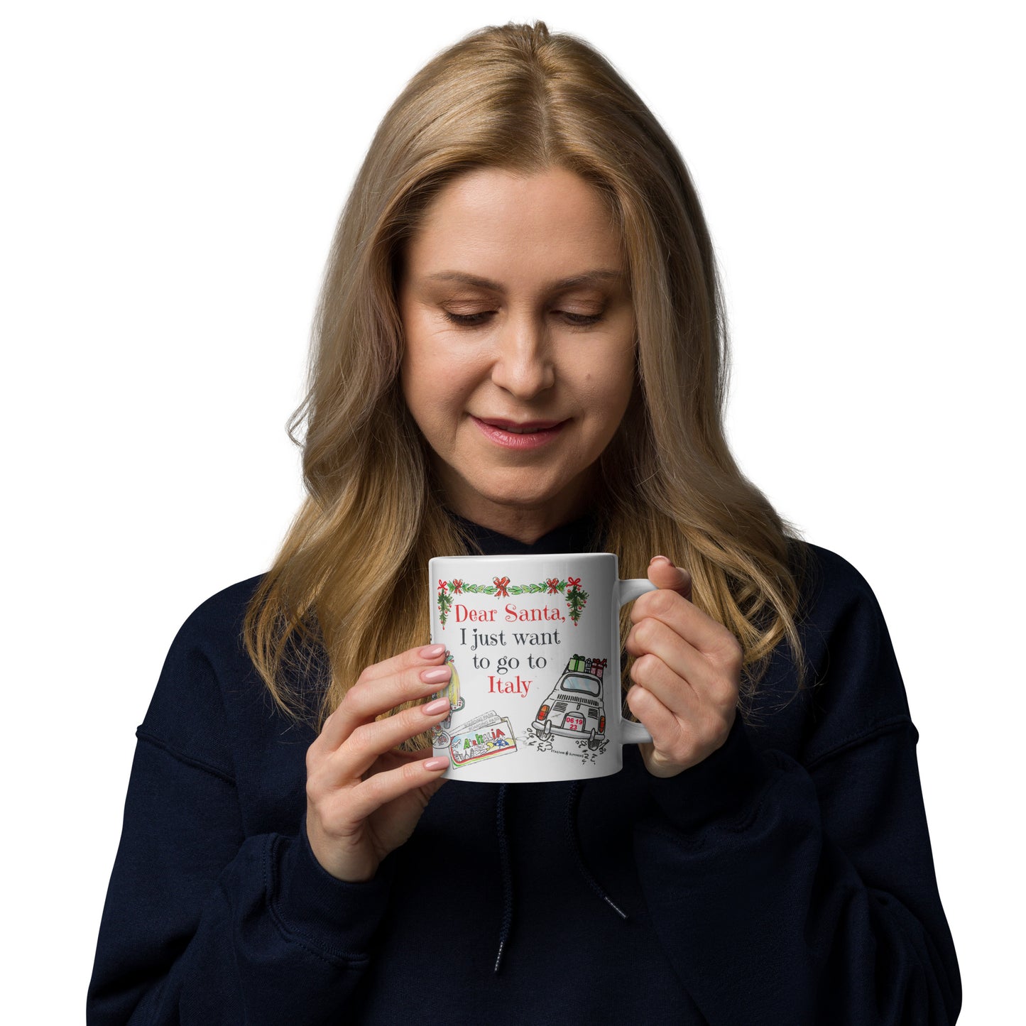 A Jumbo sized Christmas mug inspired by Italy, it features a quote of "Dear Santa, I just want to go to Italy" with a vintage Fiat 500 car speeding away wtih presents piled on the roof, some airline tickets to Italy, and Italian Christmas cakes. On the other side is a scene of a fireplae a window with a snowy Italian landscape, and presents.