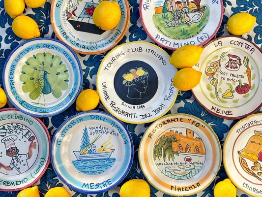 Collection of Italian vintage Buon Ricordo plates, Italian vintage restaurant plates displayed with lemon