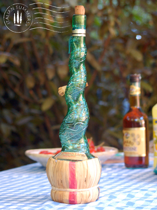 Empoli Genie Bottle, Chianti wicker glass flask, A beautiful Italian vintage wine decanter from the 1950s-60s. Emerald green glass and a spiraling floral embossing along the bottle's convoluted profile.  true find