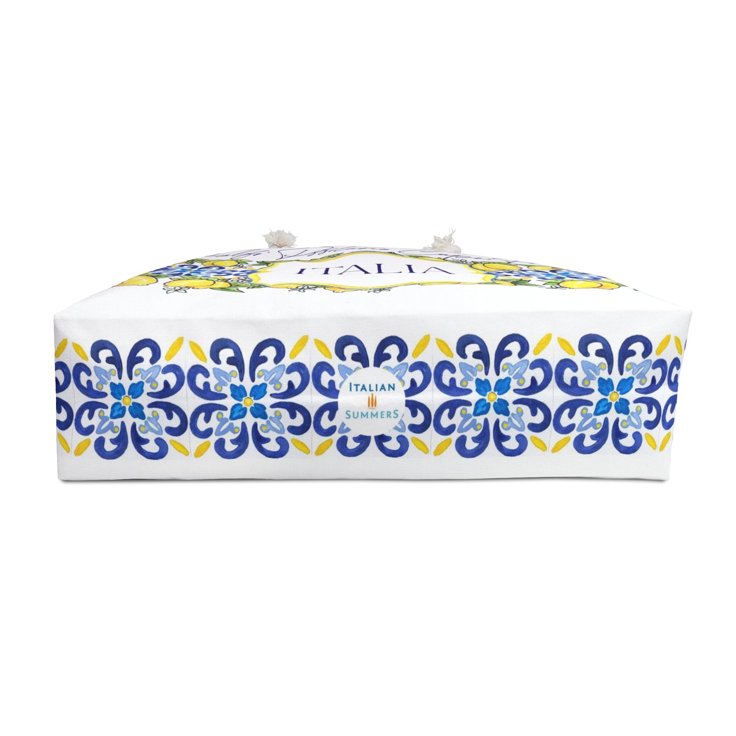 Italy-inspired XL Beach Bag  with printed blue Italia tiles in a  large band across the entire bag , framed with garlands of sunny, leafy Sorrento Lemons  with flowers. A large cartouche -like crest in the middle has the word  ITALIA - made by Italian Summers