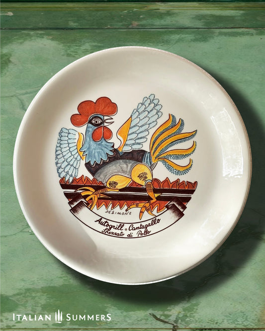 An Italian Vintage ceramic plate with the design by De Simone featuring a stylized rooster, with a cartouche of the name of an Autogrill restaurant and a typical dish of the same.