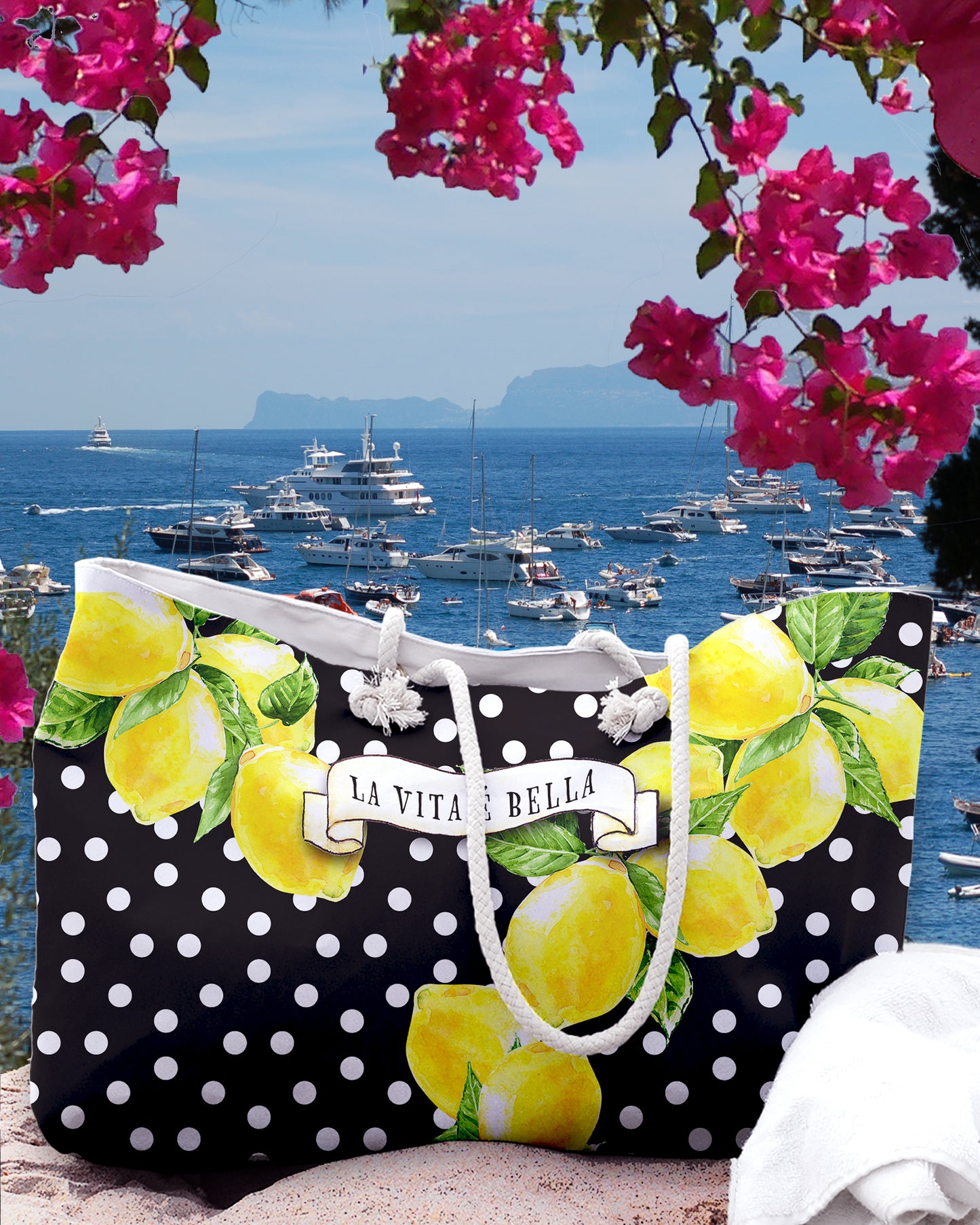 Italy inspired large beach bag with a black background and white polka dots. Big Sorrento lemons on two sides and the writing La vita 'e bella on a scroll in the middle of the bage. Designed by Italian Summers