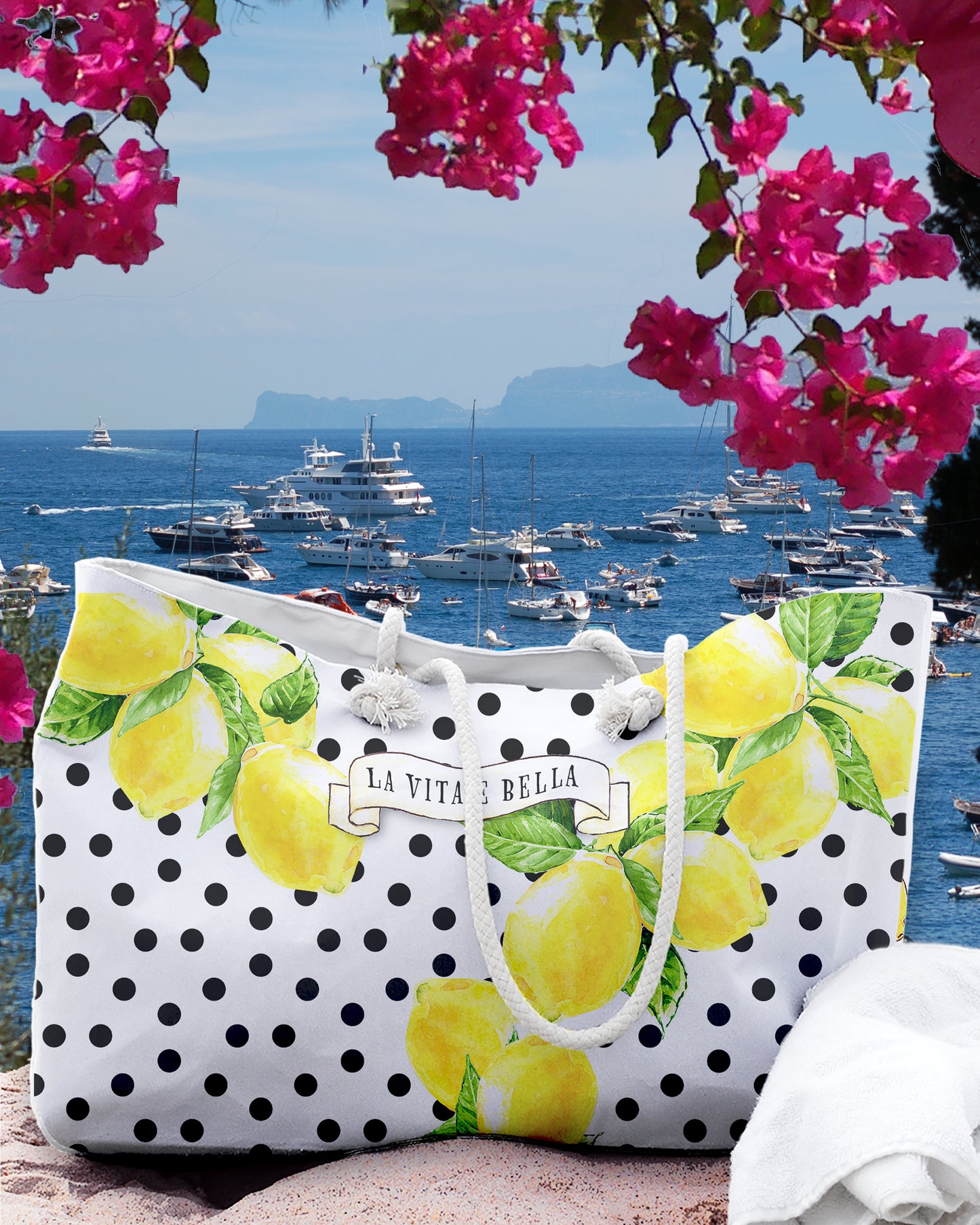 Italy inspired large beach bag with a white background and black polka dots. Big Sorrento lemons on two sides and the writing La vita 'e bella on a scroll  in the middle of the bage. Designed by Italian Summers