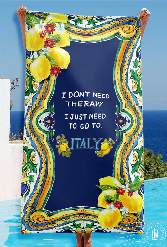 Italy inspired beach towel with a baroque Sicilian maiolica tile design  framing a field of either navy or white  with the quote " I don't need therapy I just need to go to Italy'  made by Italian Summers.
