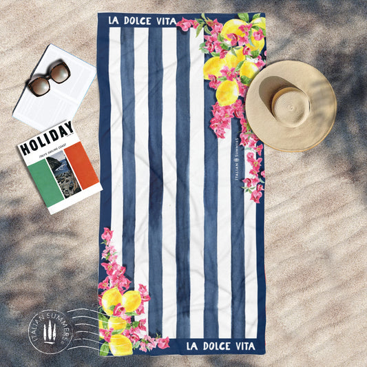 Italy inspired beach towel with a retro design from the 1950s featuring blue and white stripes, bouganvilleas and Sorrento lemons as well as the quote of " La Dolce Vita". Made by Italian Summers