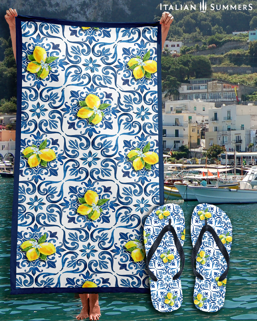 A beautiful Italy inspired beach towel printed with a pattern of blue Italian Maiolica tiles, a deep blue framing stripe and happy bunches of Sorrento lemons with flowers. Made by Italian Summers
