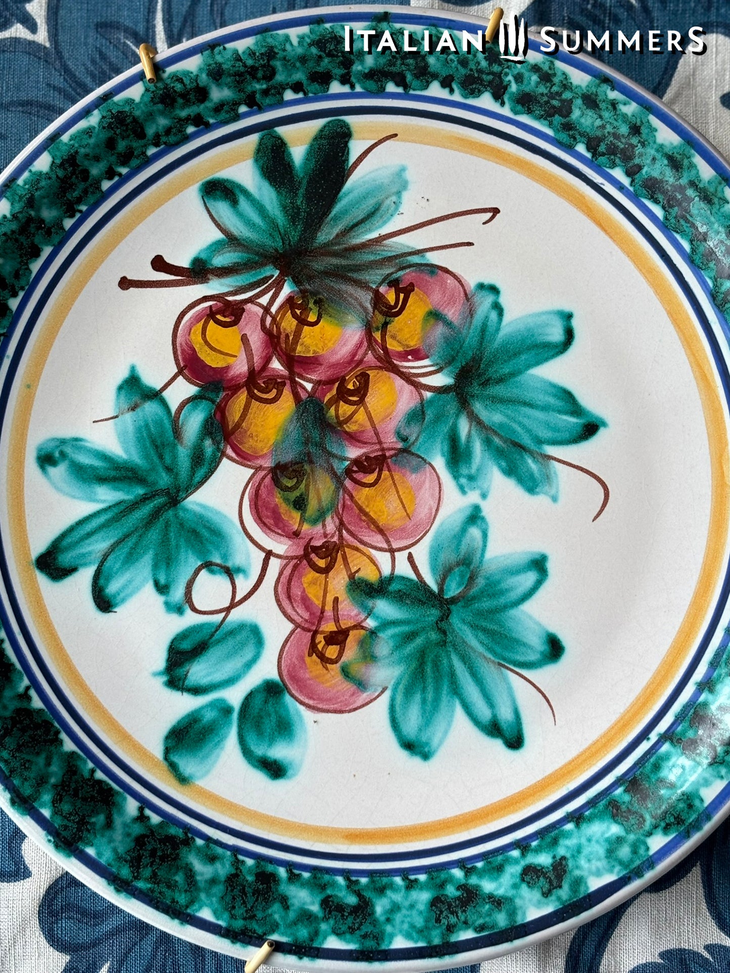 Decorative Sicilian Caltagirone maiolica ceramic plate with floral design and 'Italian Summers' branding.