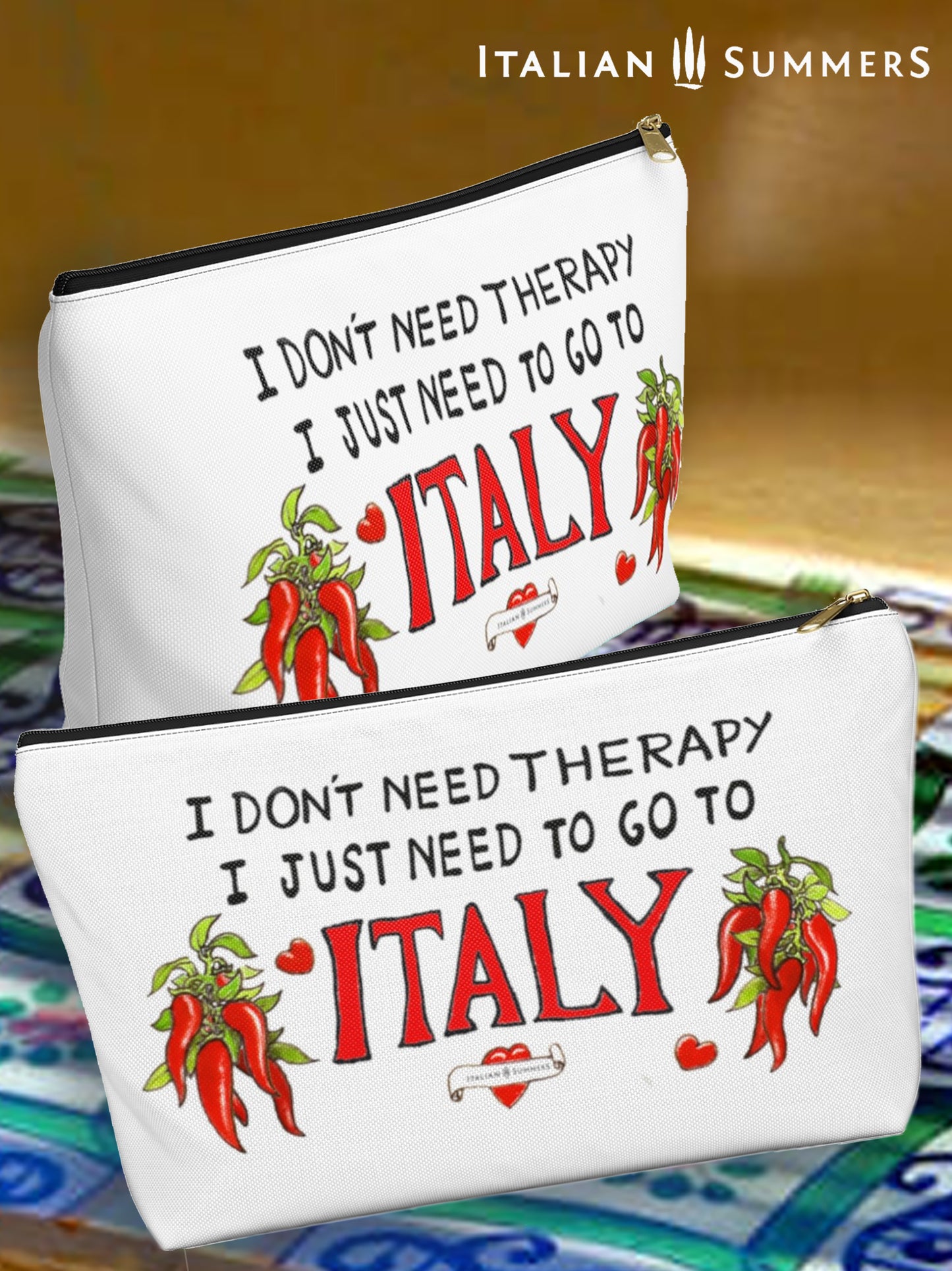 Italy inspired white canvas clutch with the quote I don't need therapy, I just need to go to Italy. The quote is in handwritten with the word Italy in red. On both sides of Italy there are bundles of peppers. The clutch has a black zipper that fits with the black text. Designed by Italian Summers 
