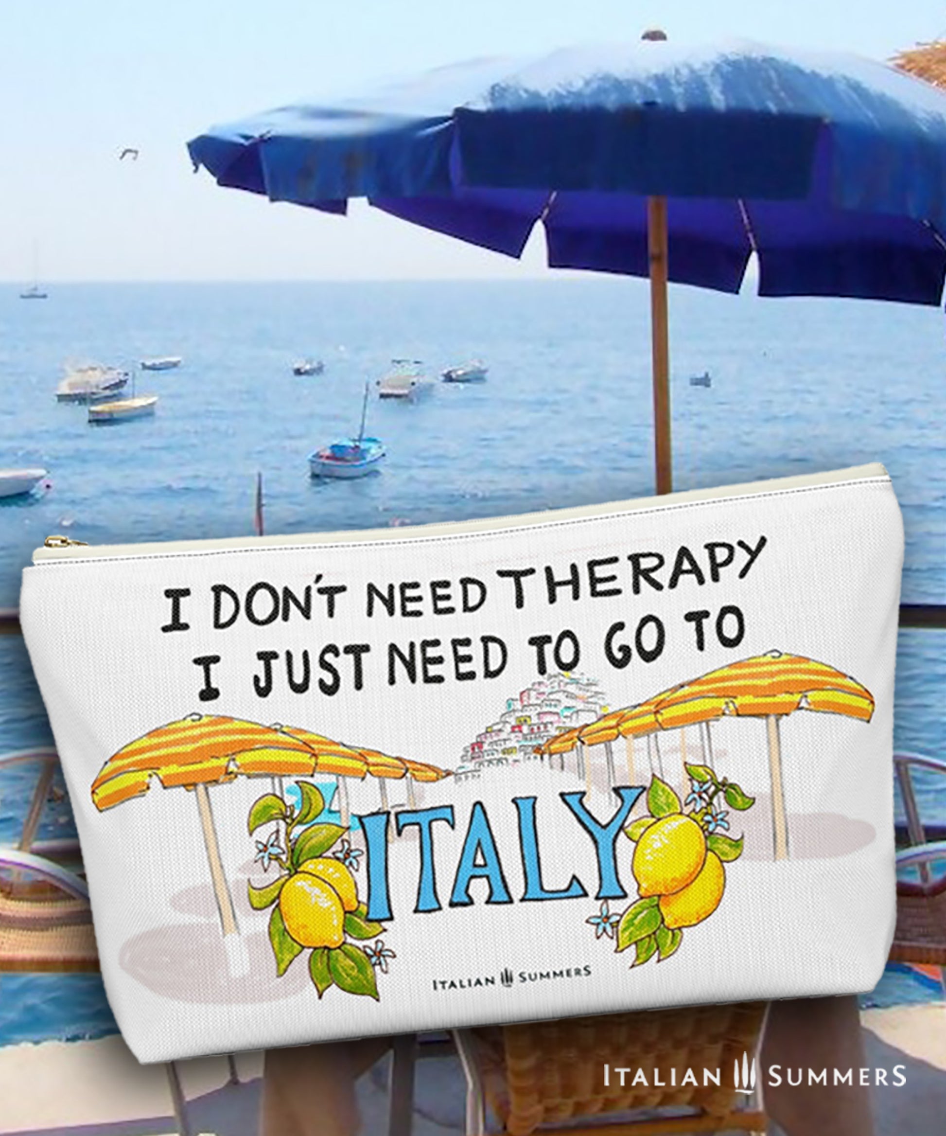 Italy inspired clutch of white canvas with he quote I don't need therapy, I just need to go to Italy. On the clutch there is a sketch of the beach umbrellas on Positano beach The beach umbrellas are yellow and orange striped. In the distance you ccan see the stagered houses of Positano. The word Italy in in big blue letters and is flancked with lemons. Designed by Italian Summers.