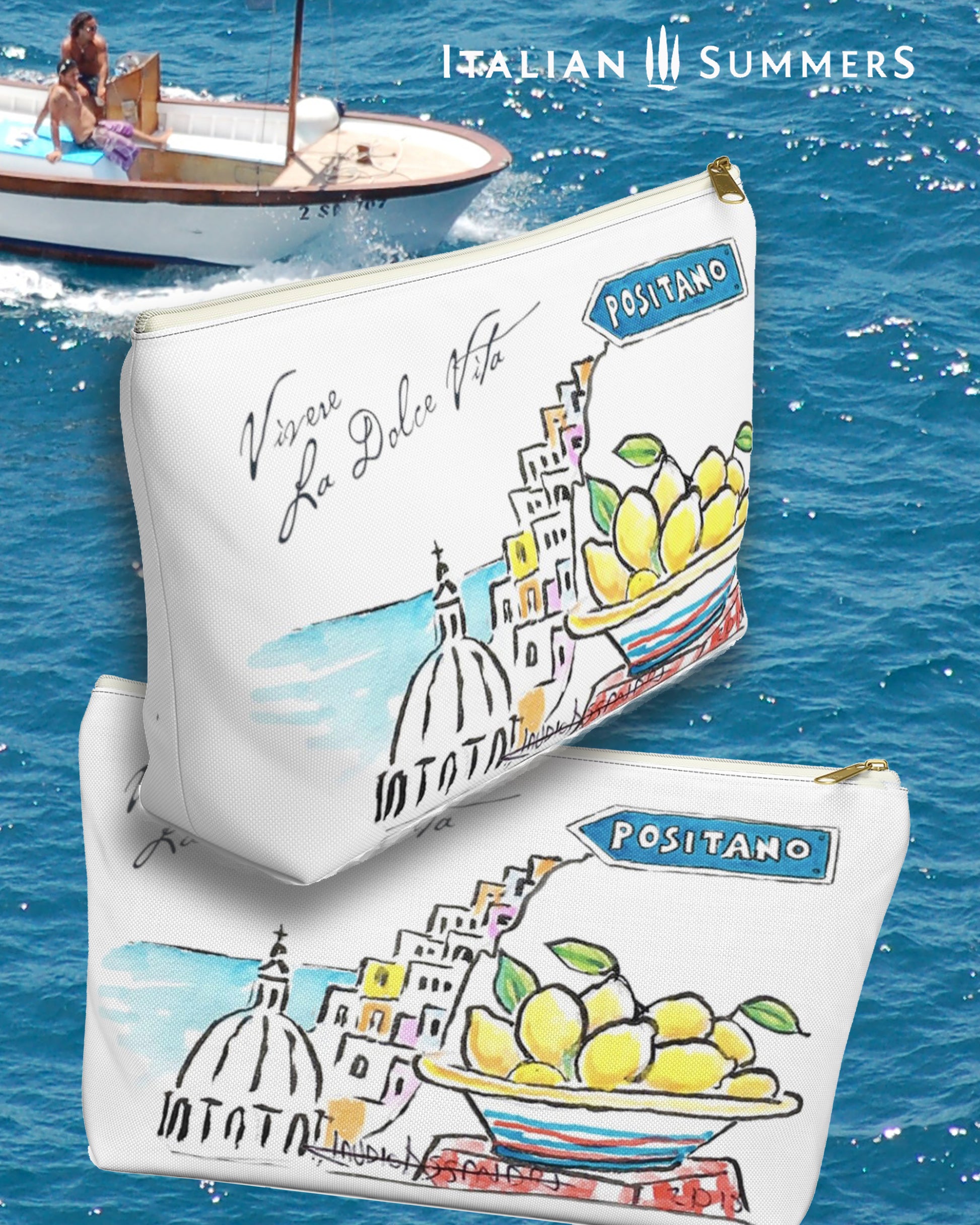 Italy inspired clutch of white canvas with the text Vivere La Dolce Vita which means Living La Dolce Vita. The clutch is decorated with a sketch of a part of Positano, the cupola of the church and some ice cream colored houses seen from the side and a big ceramic bowl of Amalfi Coast lemons, there is also a streetsign which sais Positano. Designed by Italian Summers