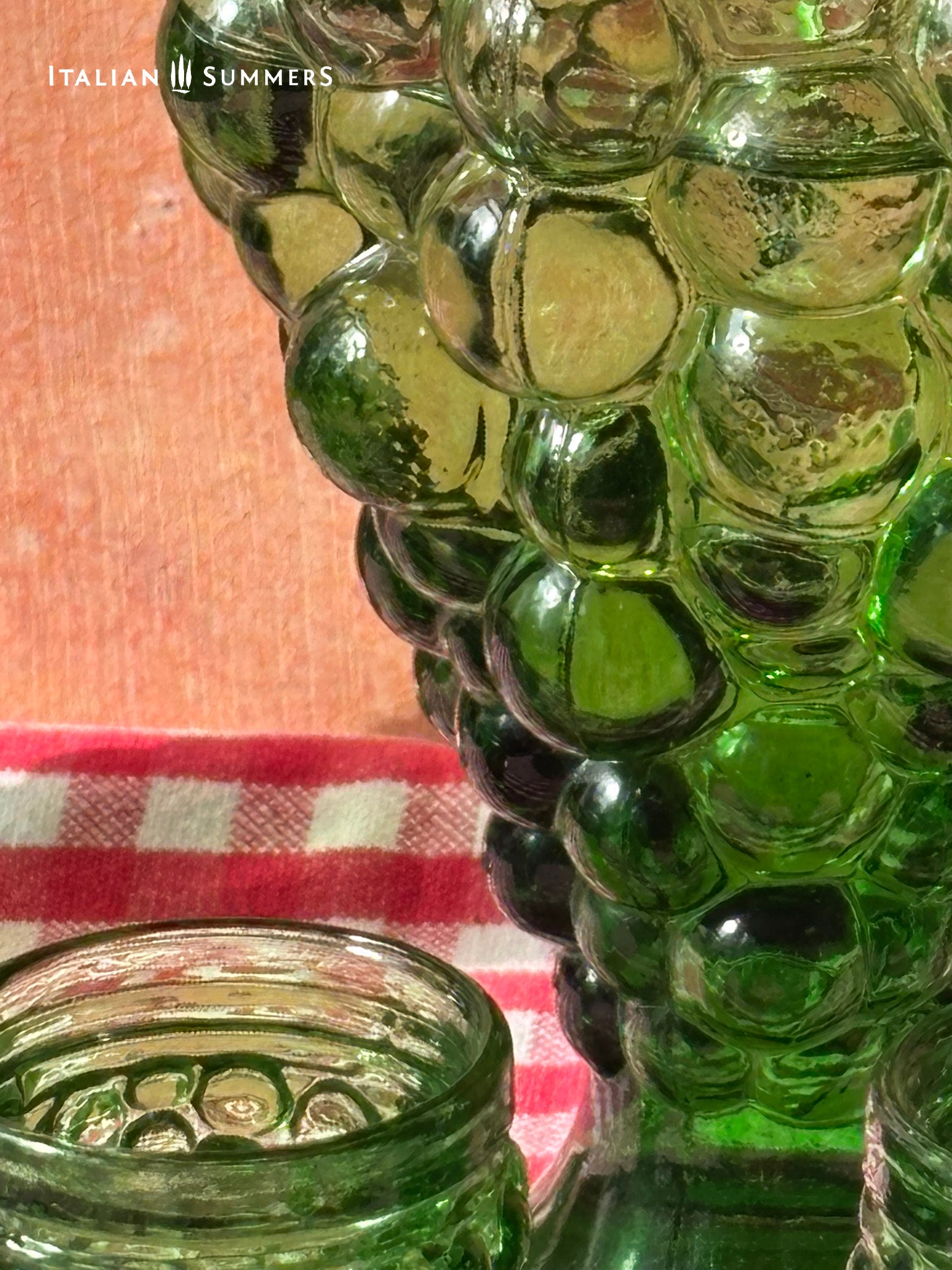 Empoli Green glass decanter detail  with bubble design on a checkered tablecloth