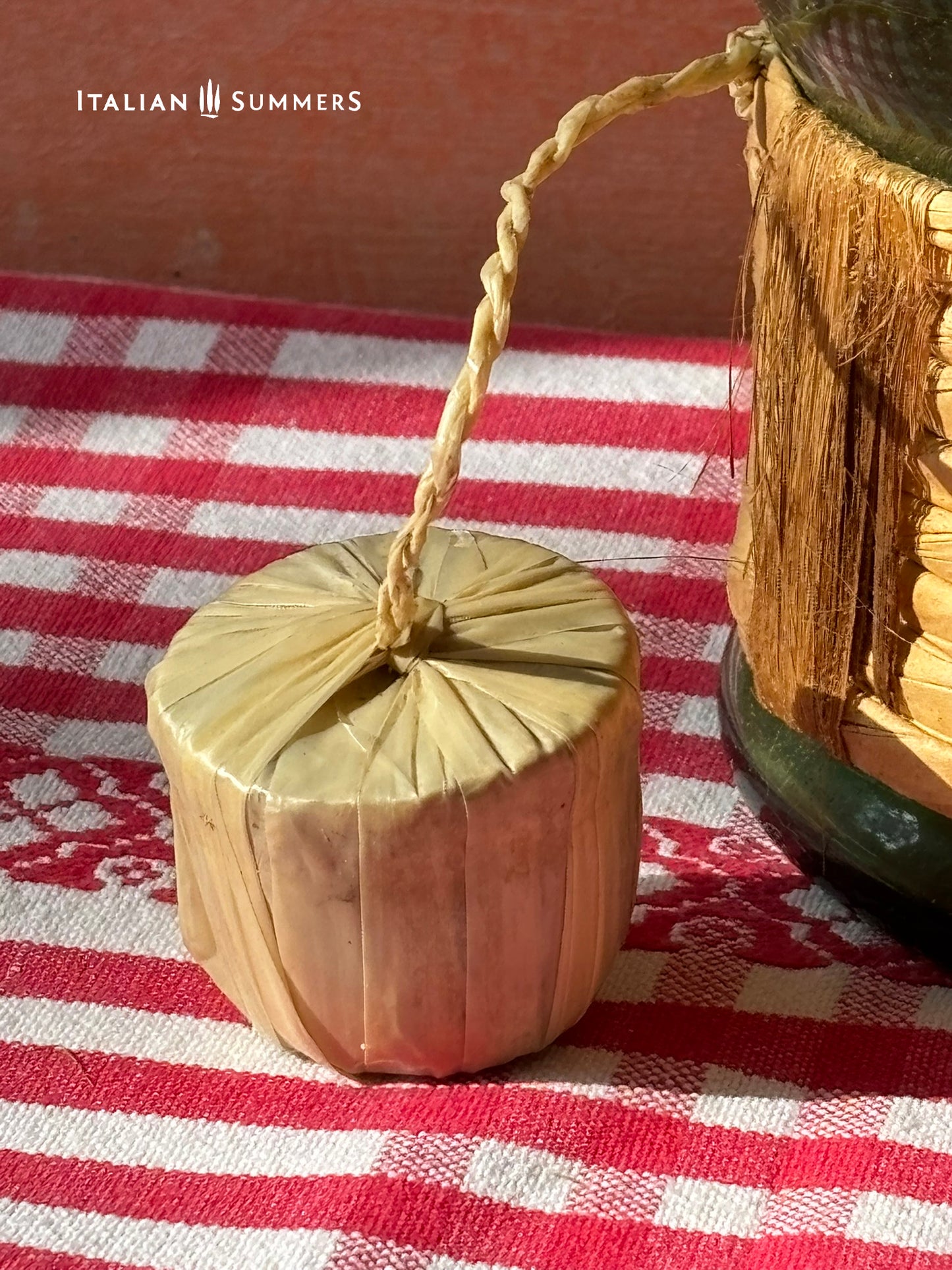 detail of a cork stopper for the ice chamber on an Empoli green glass decanter with woven sleeve.