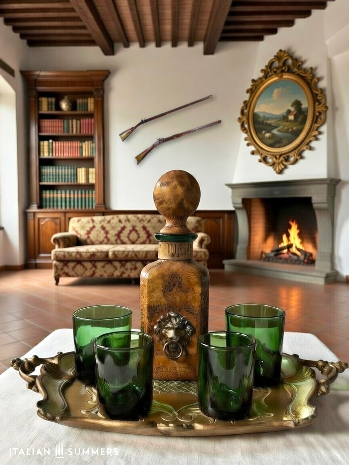 Decorative setting with emerald-green glasses and a leather-covered whiskey decanter on a tray in a room with a fireplace and bookshelf.