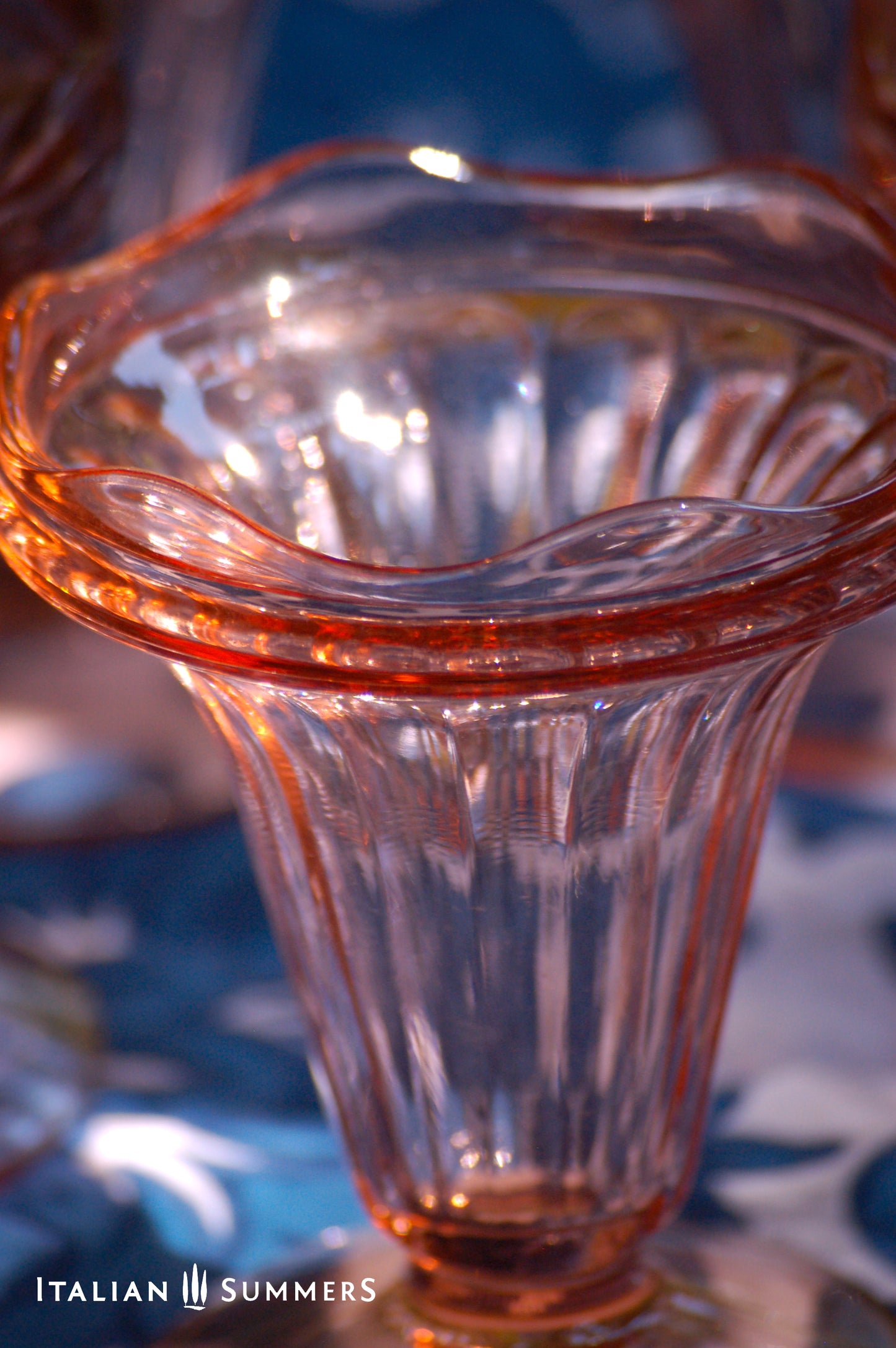 Close-up of a pink glass French Vintage dessert  coupe with 'Italian Summers' branding.