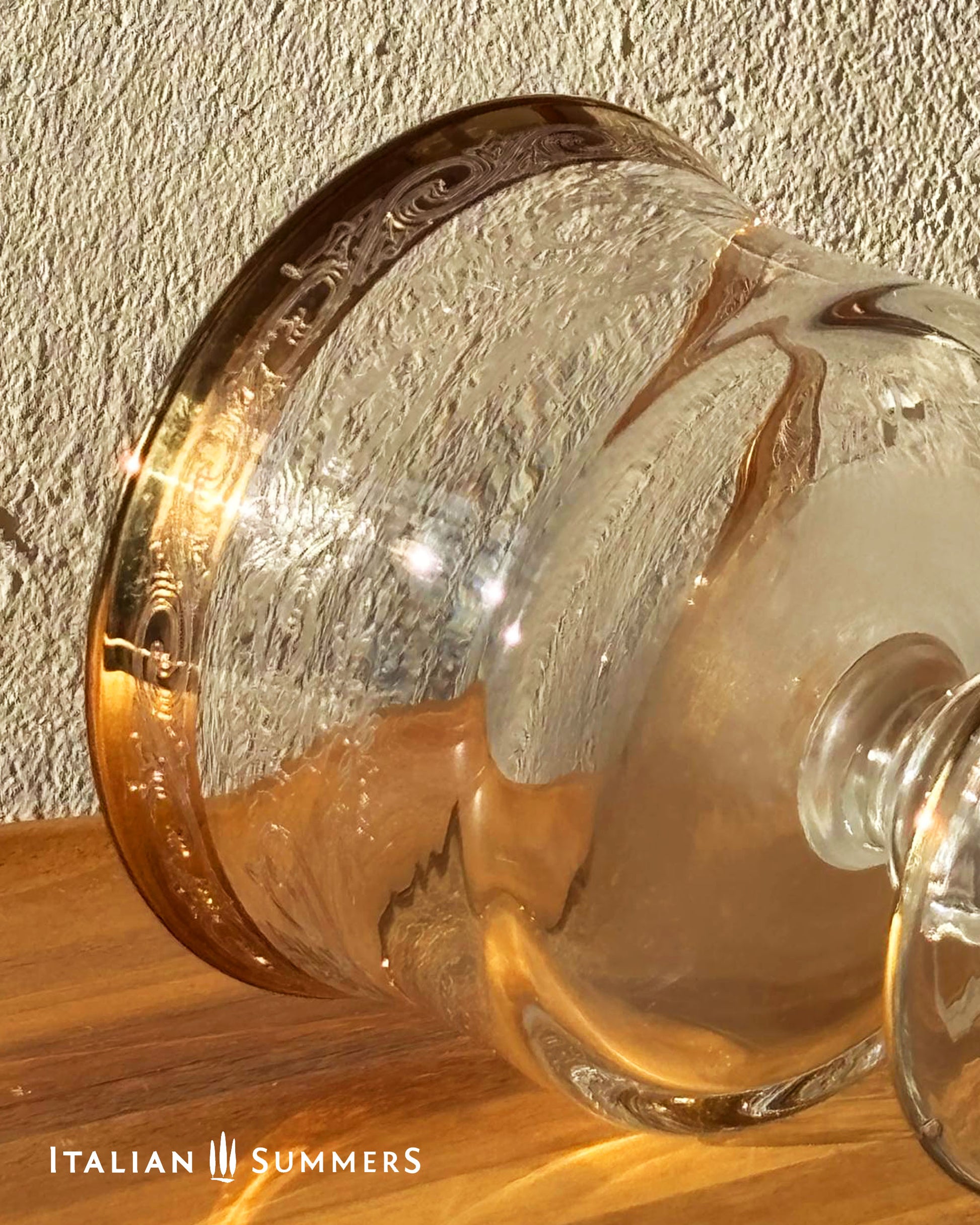 Decorative glass item with gold accents on a wooden surface, branded 'Italian Summers'.