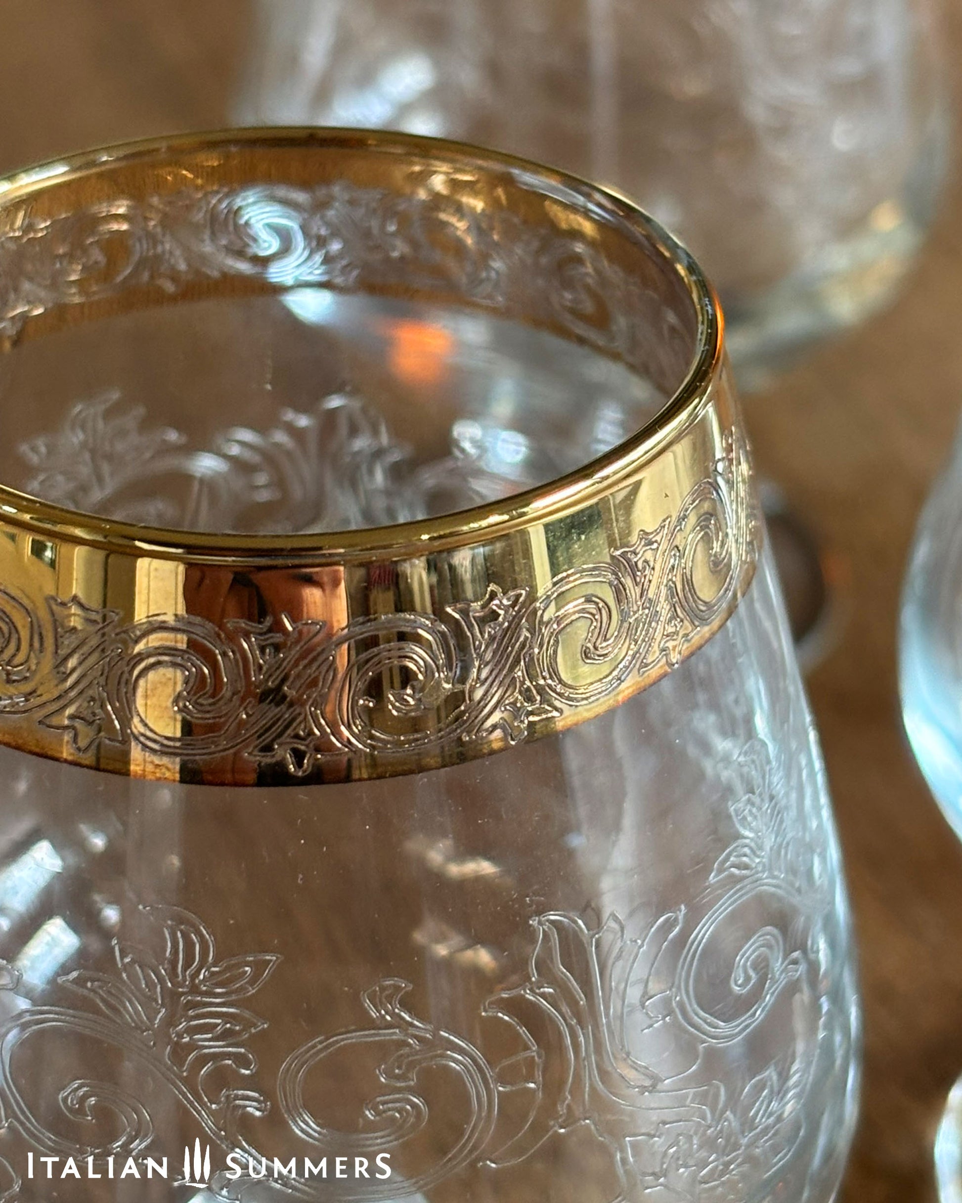 Glass with gold rim and intricate designs, brand 'Italian Summers' visible