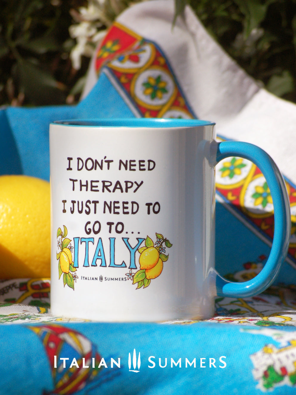 Italy inspired mug with the quote "I don't need therapy, I just need to go to Italy"  The word Italy is written in a happy blue color and has 2 lemons on every side. The mug is printed on 2 sides and is available with colored inside/handle in blue yellow and pink