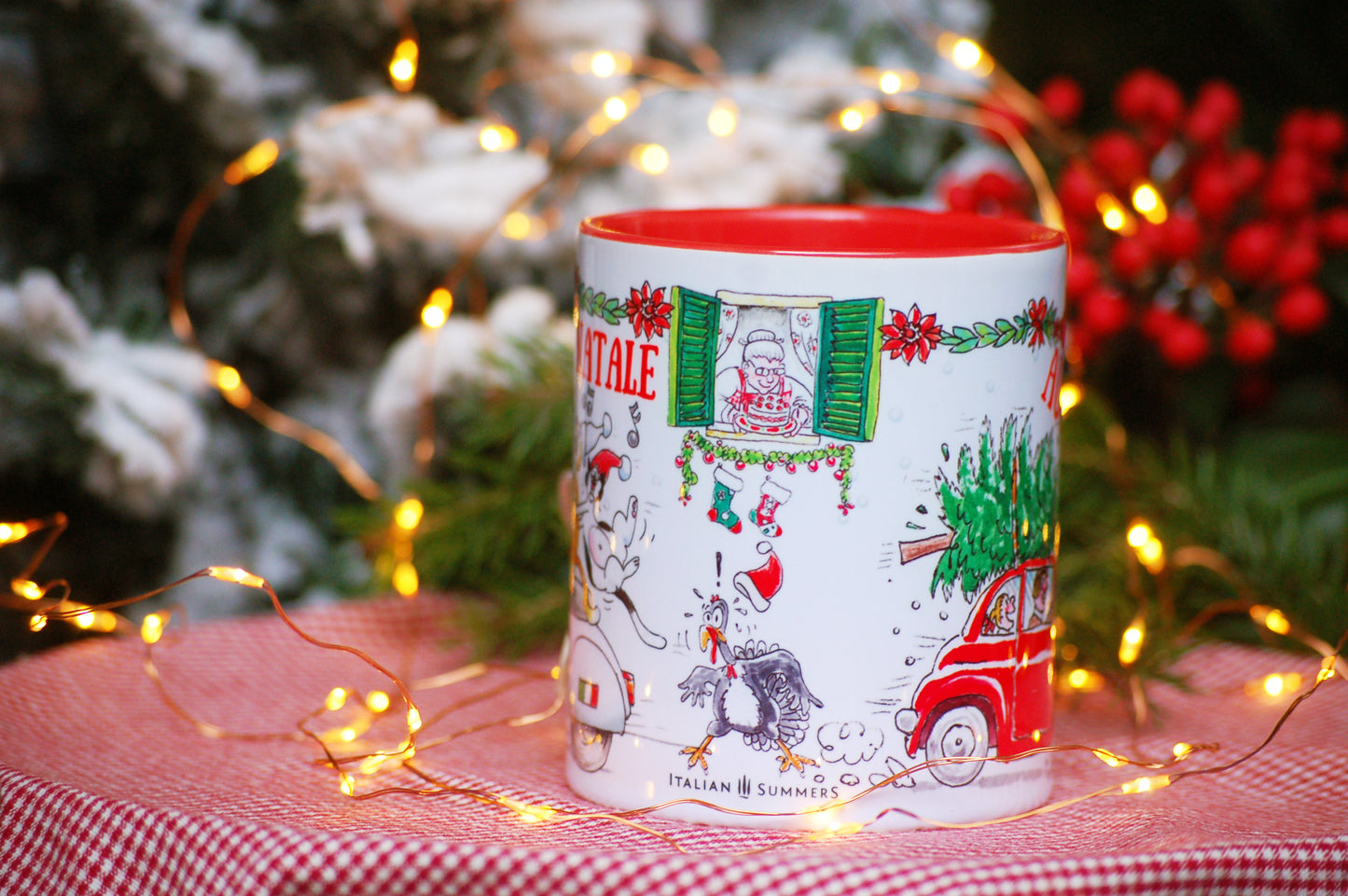 This Italy-inspired ceramic Christmas mug features the print of a merry trio of Italian cats singing carols on a vintage Vespa as they speed through an Italian street. A cute vintage red Fiat500 car zooms in the opposite direction with a Christmas tree on the roof!