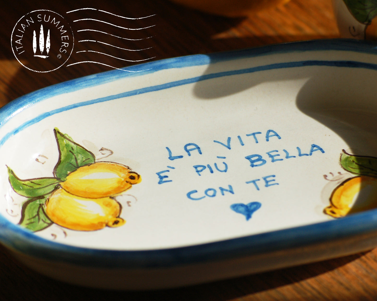 A bright and colorful Italian Maiolica ceramic espresso coffee set, two demitasse and a serving tray featuring sunny Sicilian lemons and a blue decoration with the Italian text -La vita e&#39; piu bella con te-.  hand made in Sicily