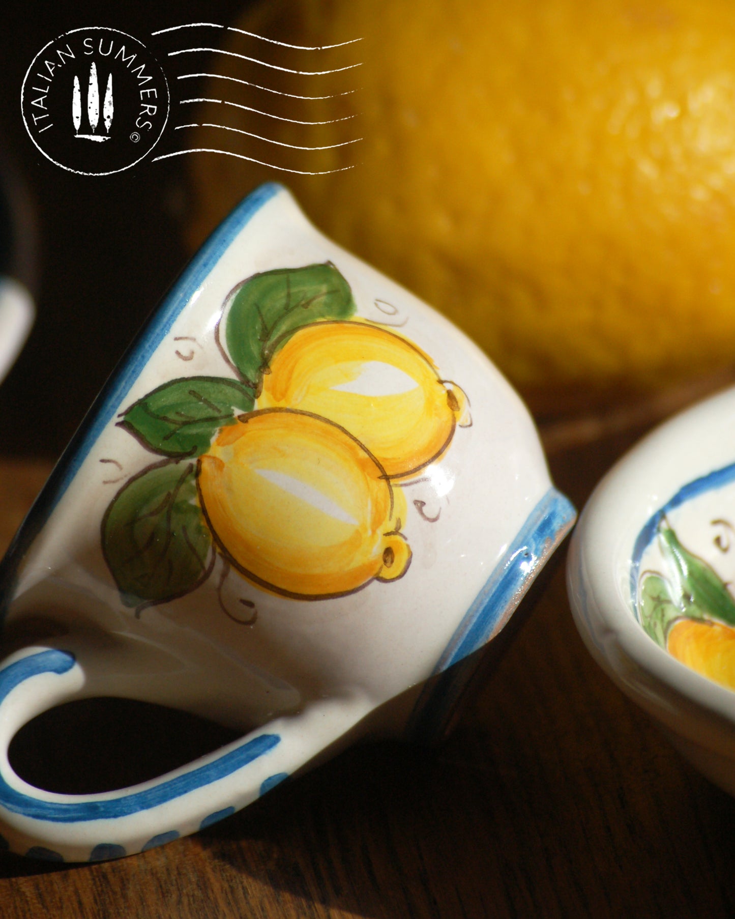 A bright and colorful Italian Maiolica ceramic espresso coffee set, two demitasse and a serving tray featuring sunny Sicilian lemons and a blue decoration with the text Buongiorno which means Good Morning in Italian.  hand made in Sicily