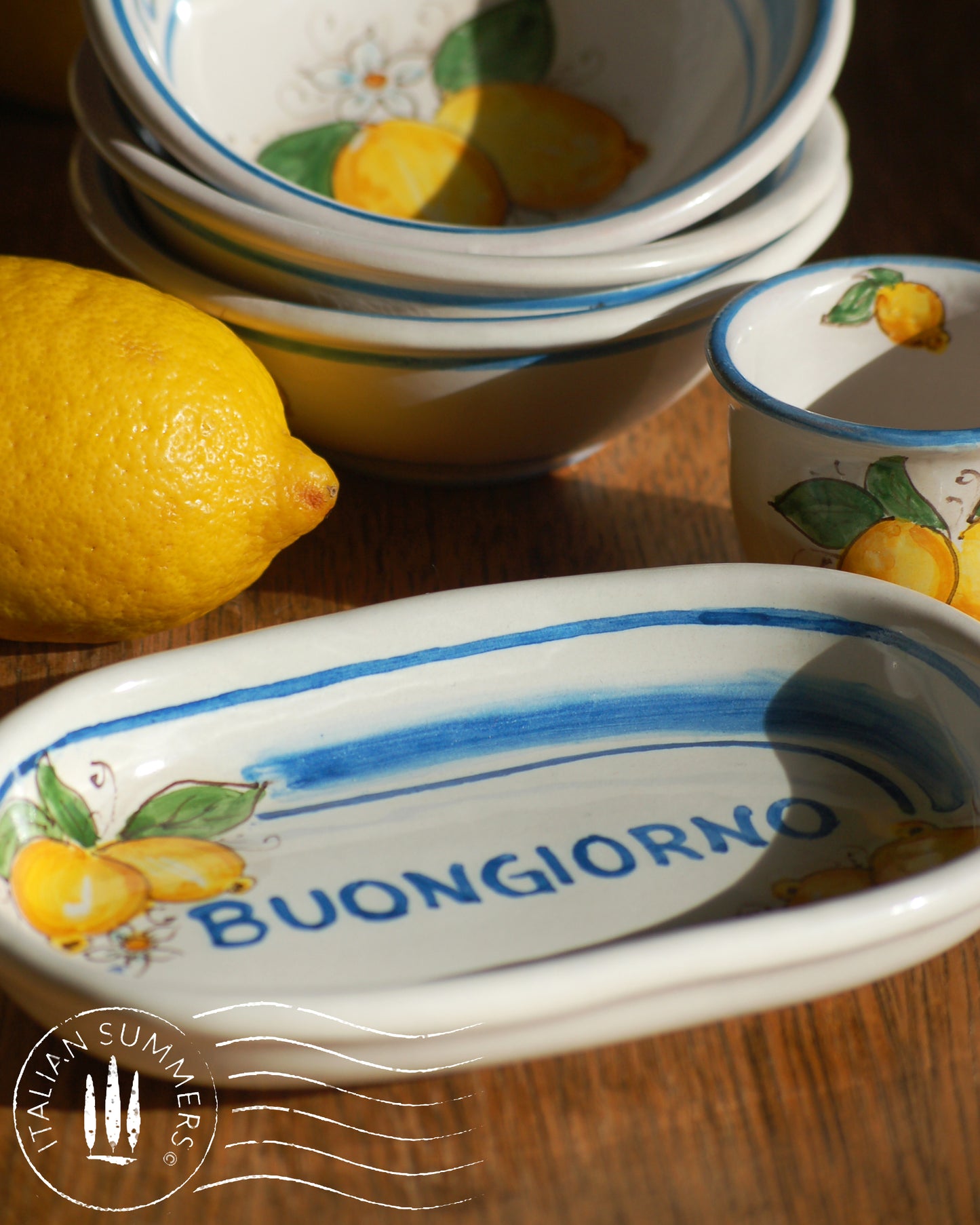 A bright and colorful Italian Maiolica ceramic espresso coffee set, two demitasse and a serving tray featuring sunny Sicilian lemons and a blue decoration with the text Buongiorno which means Good Morning in Italian.  hand made in Sicily