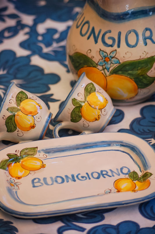 Italian ceramic breakfast set made up of two espresso cups with a tray, and wo bowls. All decorated with light marine blue stripes and vibrant hand painted Amalfi Coast lemons. The tray has the tex: "La vita e' piu bella con te" (life is more beautiful with you) or "Buongiorno" Artisan-made on the island of Sicily