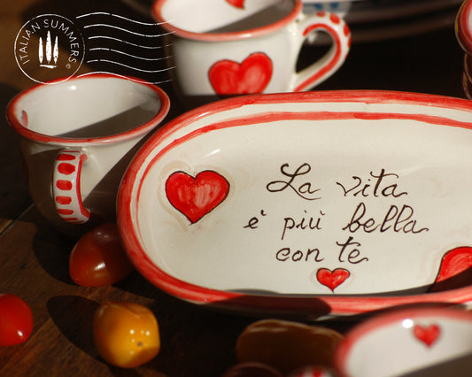 A bright and colorful Italian Maiolica ceramic espresso coffee set, two demitasse and a serving tray featuring happy Sicilian red hearts and a decoration with the Italian text -La vita e&#39; piu bella con te-.  hand made in Sicily