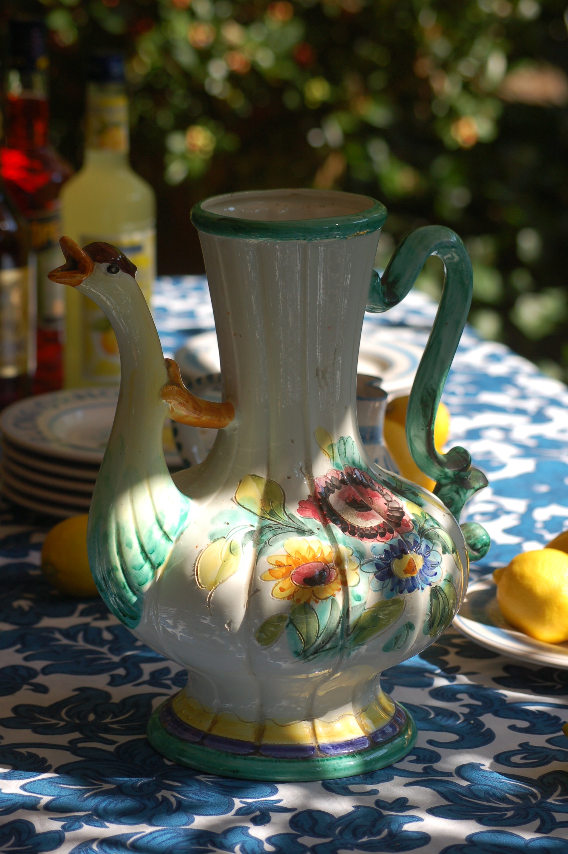 Italian vintage carafe decorated with flowers and goose head from the sixties side view