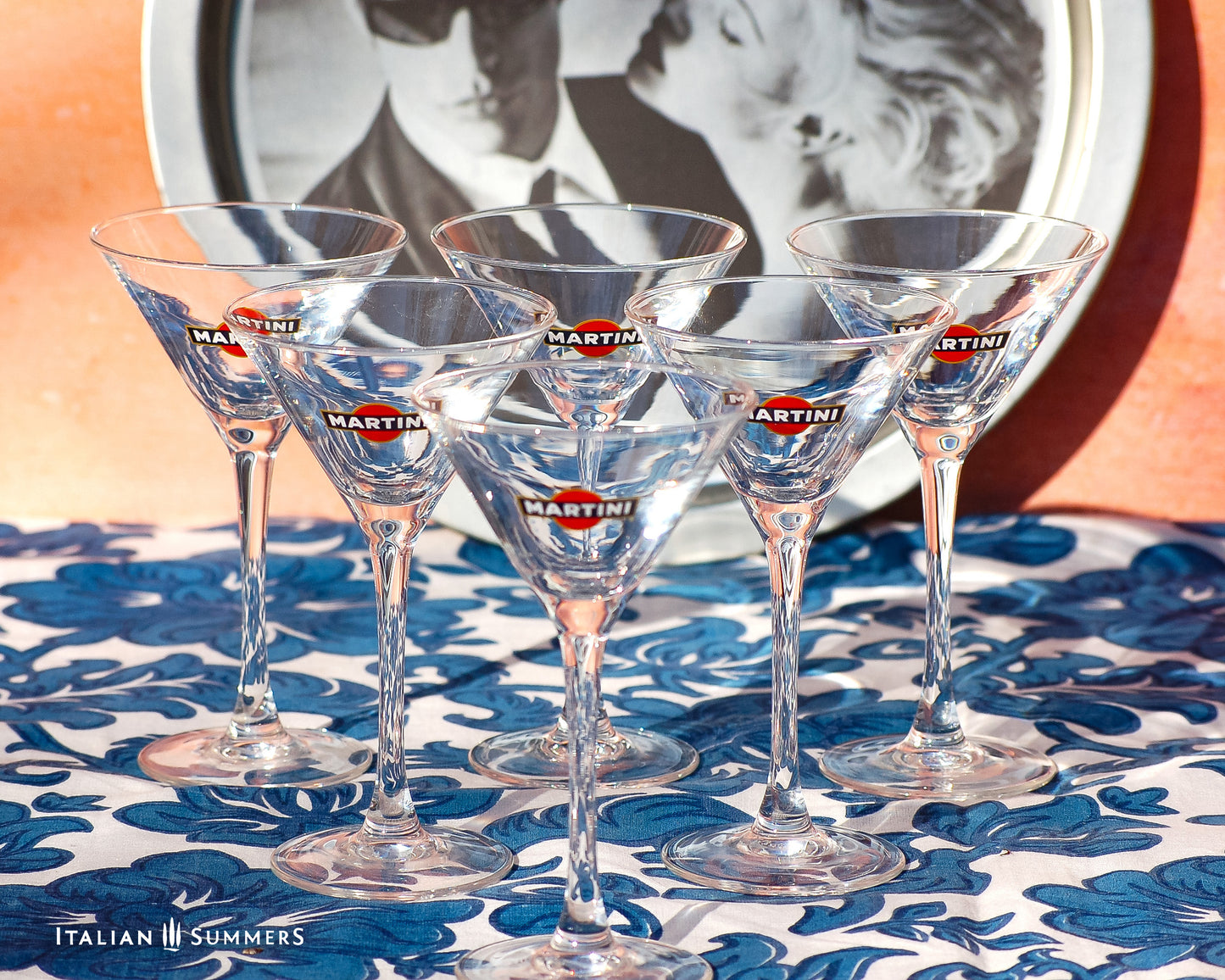 Set of Martini glasses on a floral tablecloth with a blurred background
