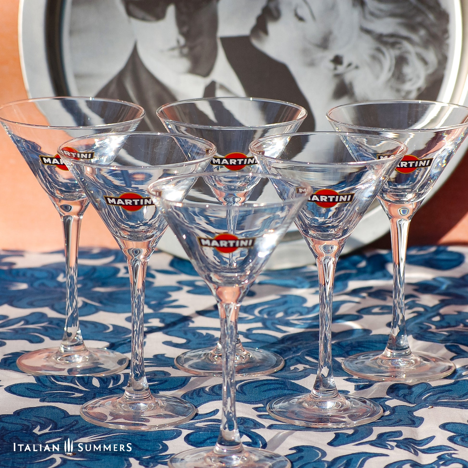 Set of Martini glasses on a patterned tablecloth with a blurred background