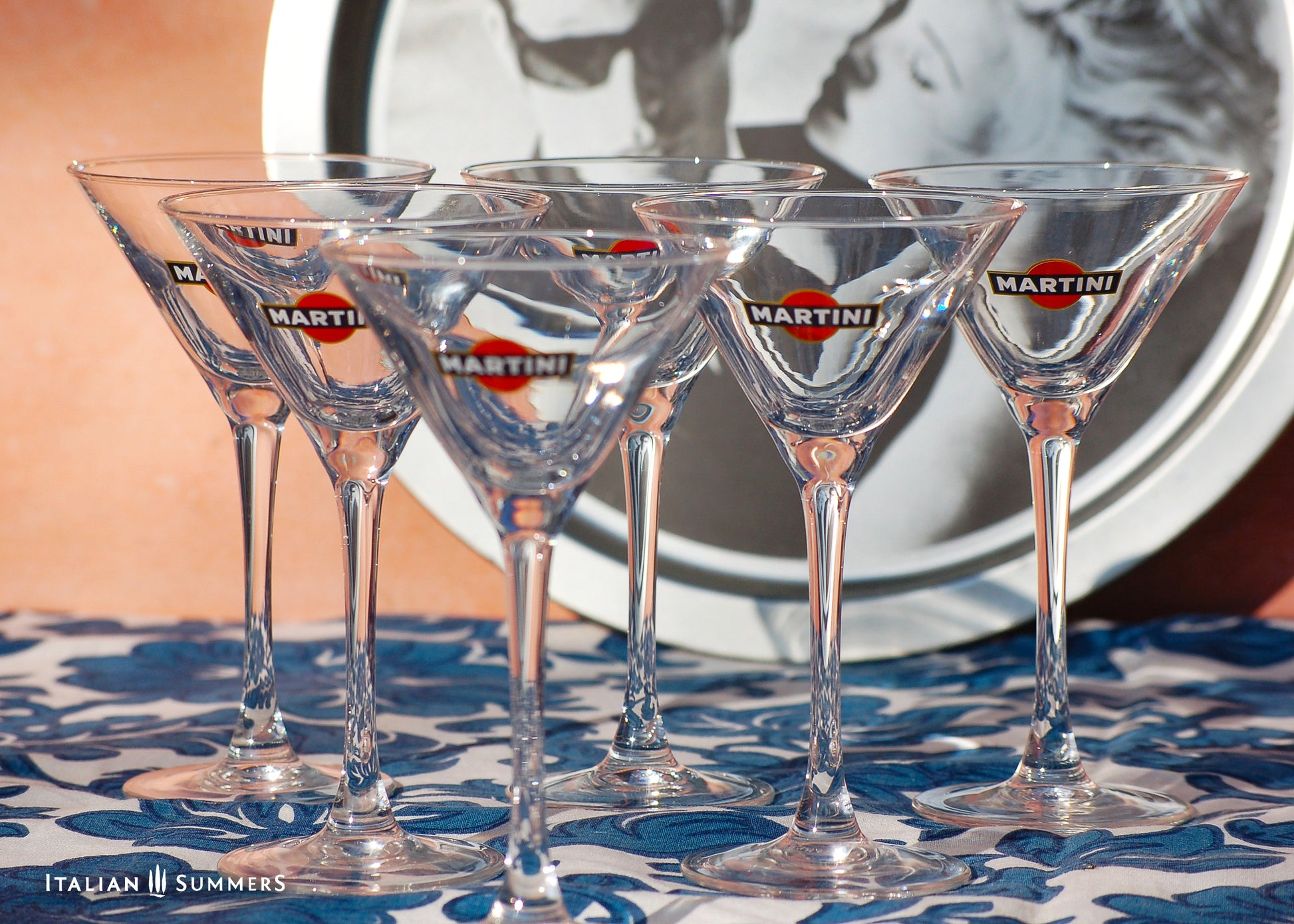 Set of Martini glasses on a patterned tablecloth with a blurred background