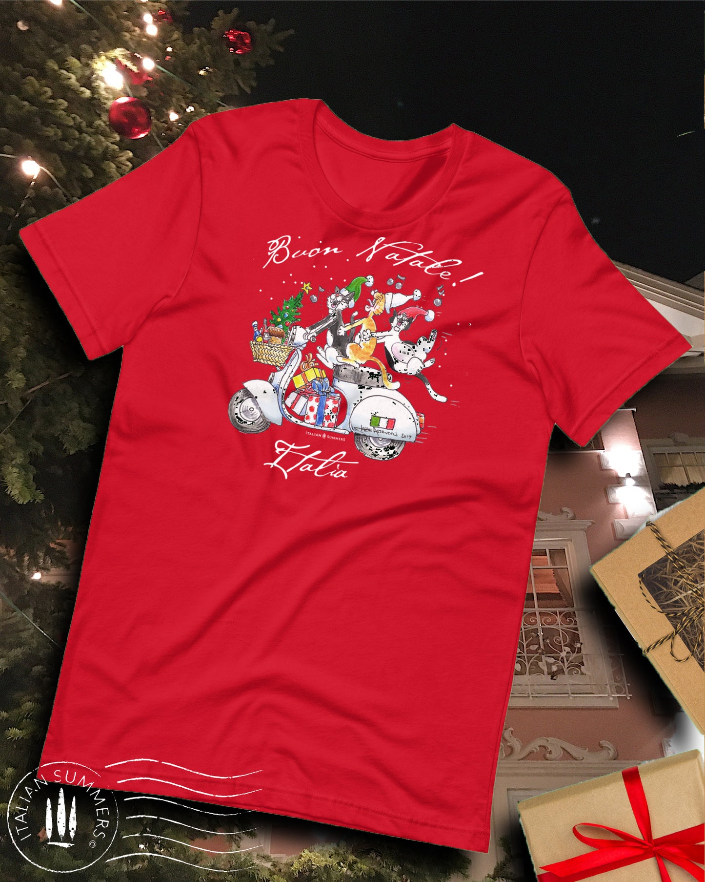 Photo of a red T Shirt with a happy print of a drawing of three Italian cats riding a vintage white Vespa scooter and singing  "Buon Natale!"  - Merry Christmas In Italian.
